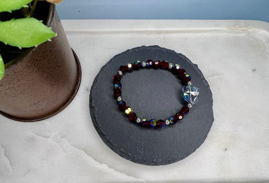 a beaded bracelet sitting on top of a stone