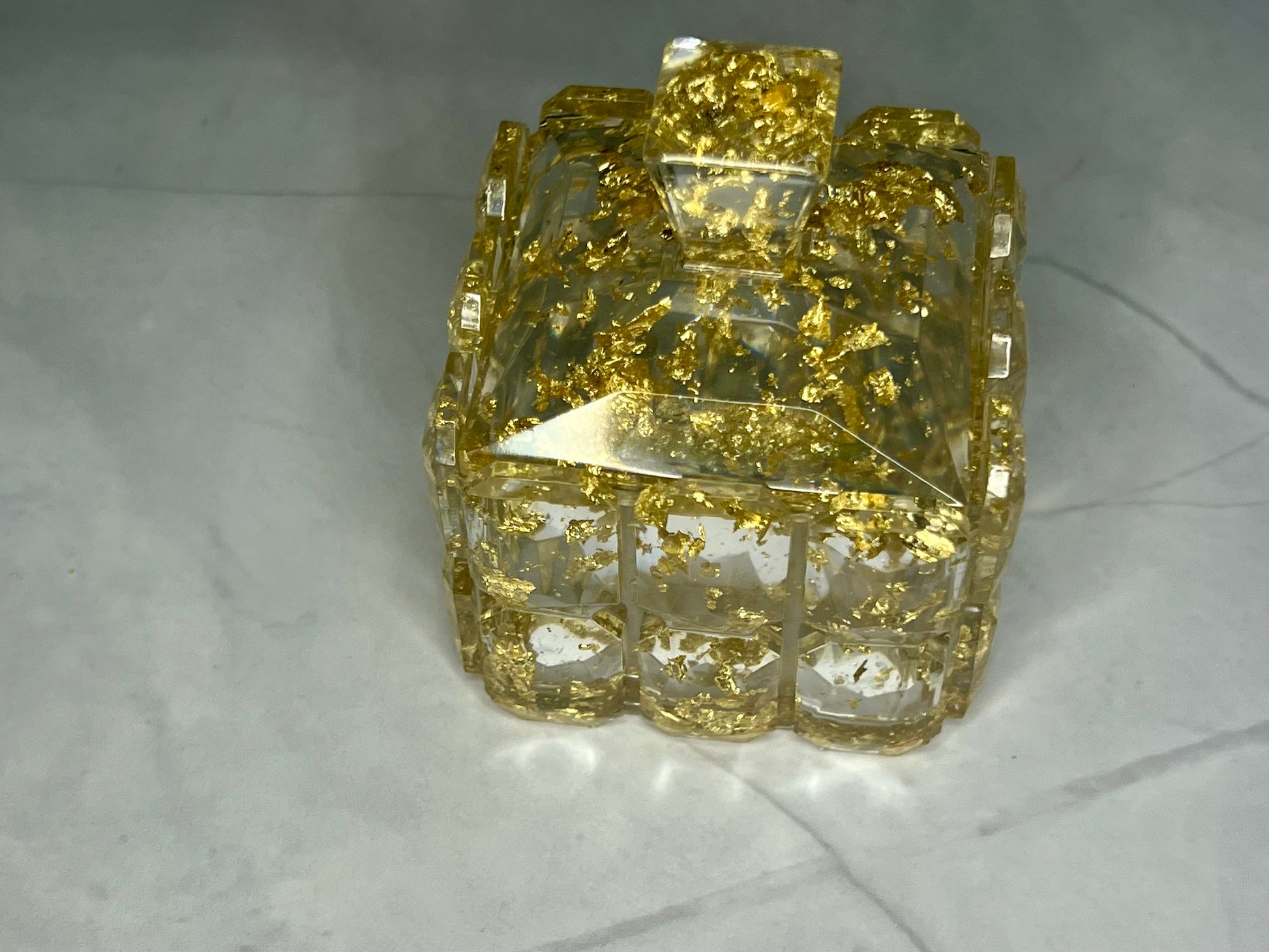 a yellow diamond ring sitting on top of a white table