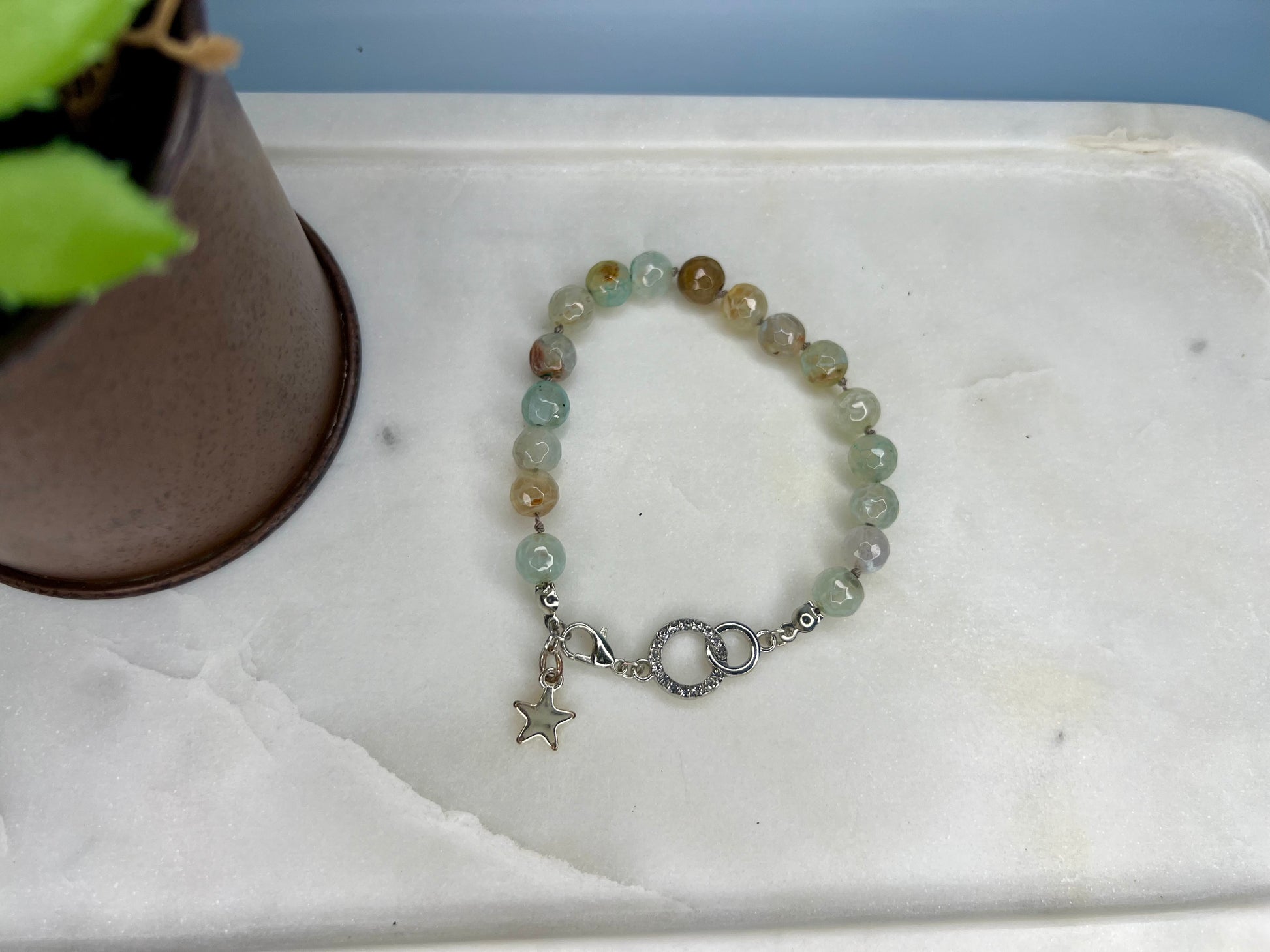 a bracelet with a star charm on it