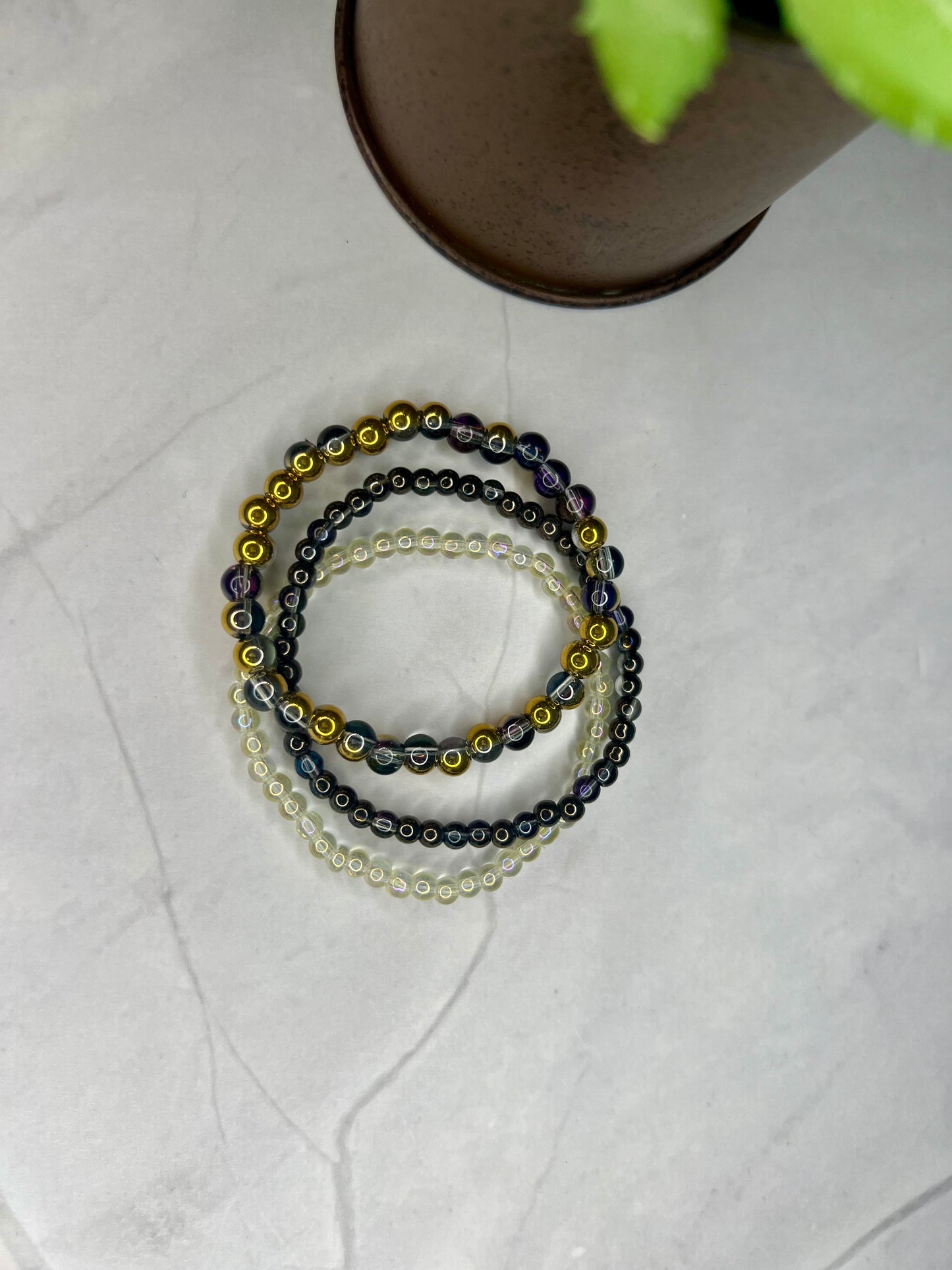 a set of three beaded bracelets sitting on top of a table