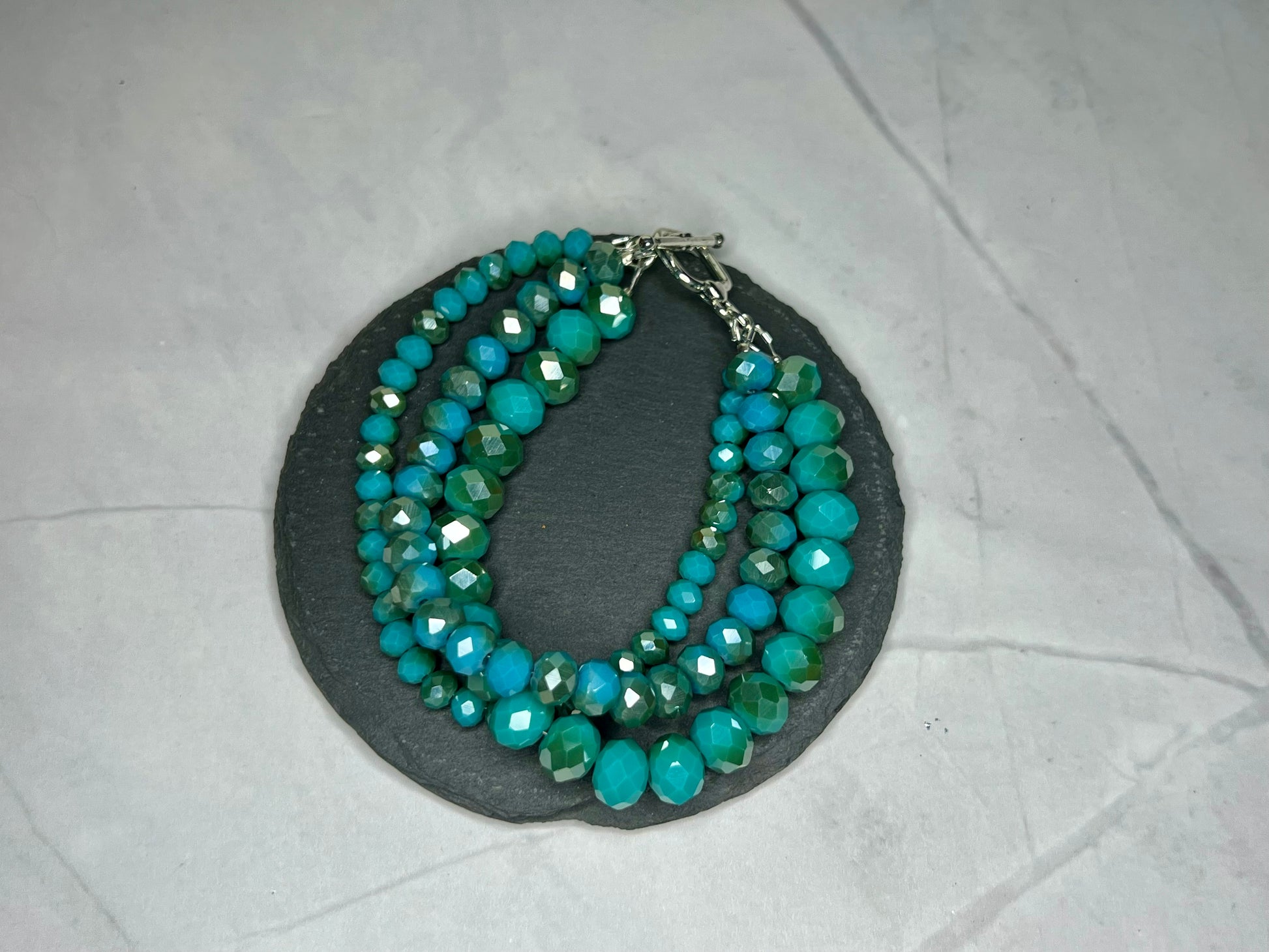 a multi strand of turquoise and green beads