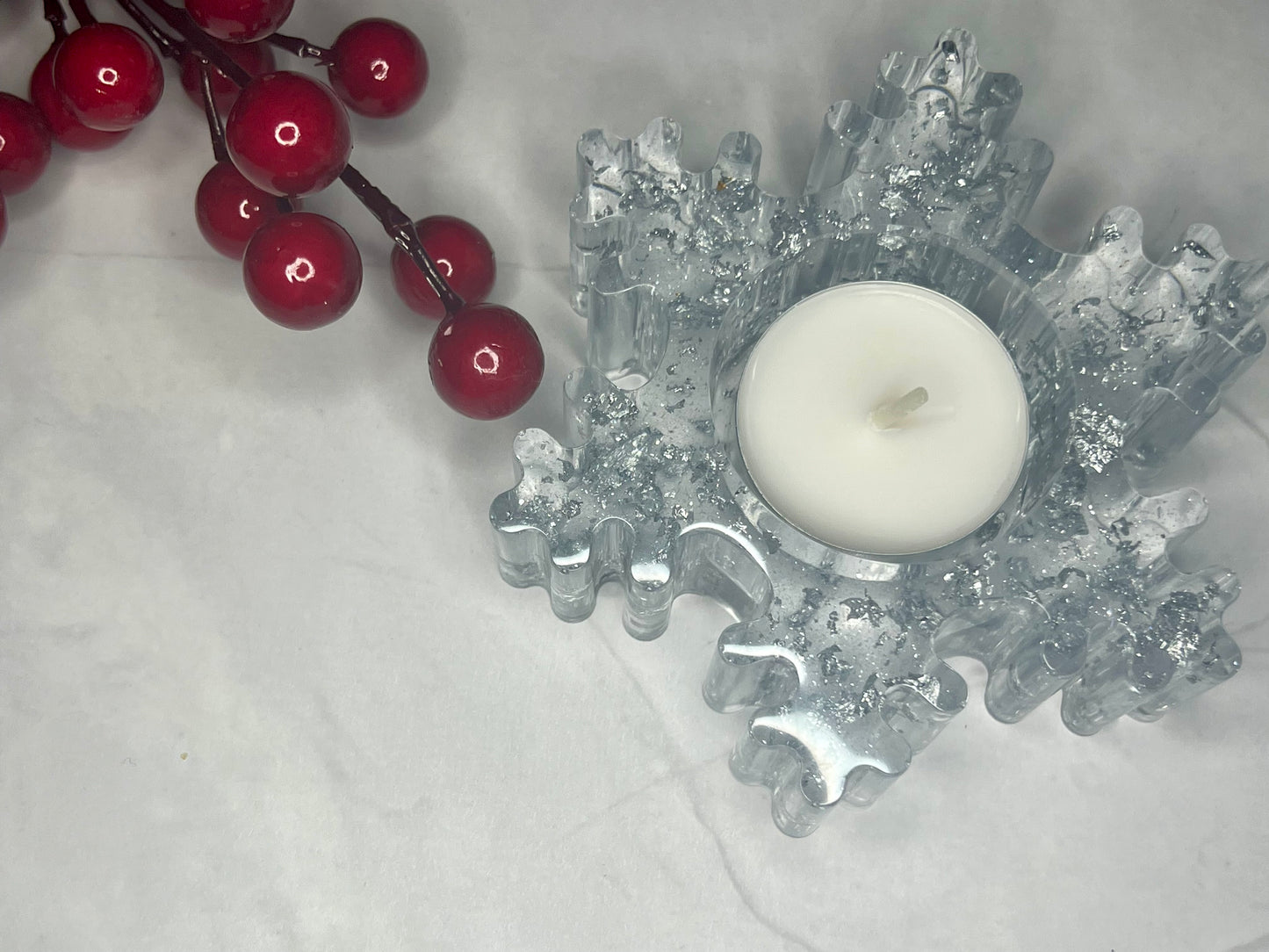 a candle and some cherries on a table