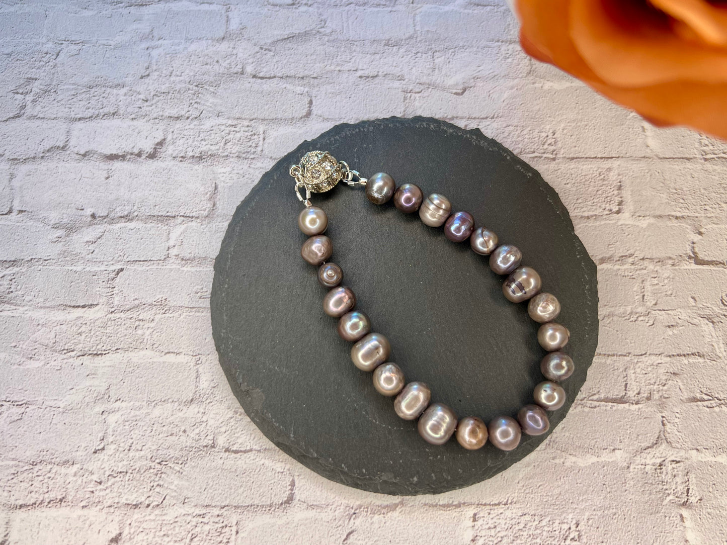 a necklace of pearls on a stone circle