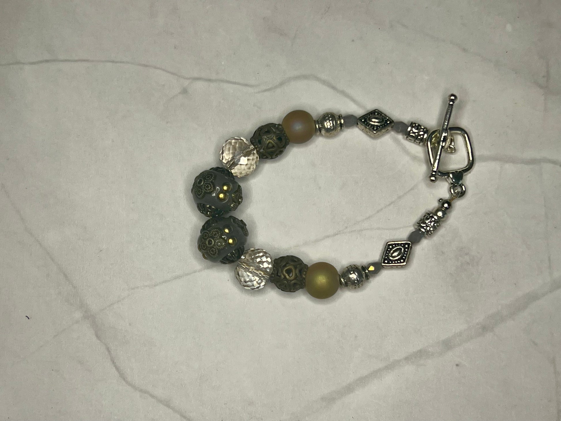 a close up of a bracelet on a table