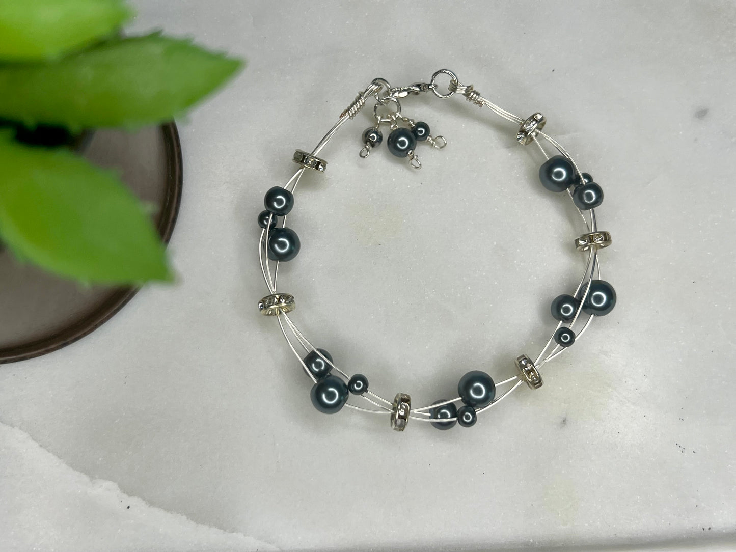 a bracelet with black beads and silver beads