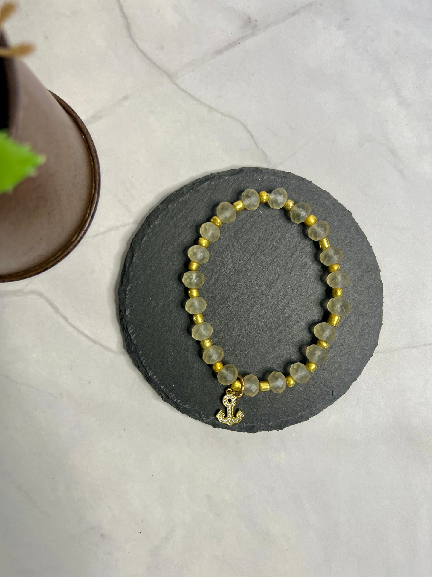 a yellow beaded bracelet sitting on top of a table