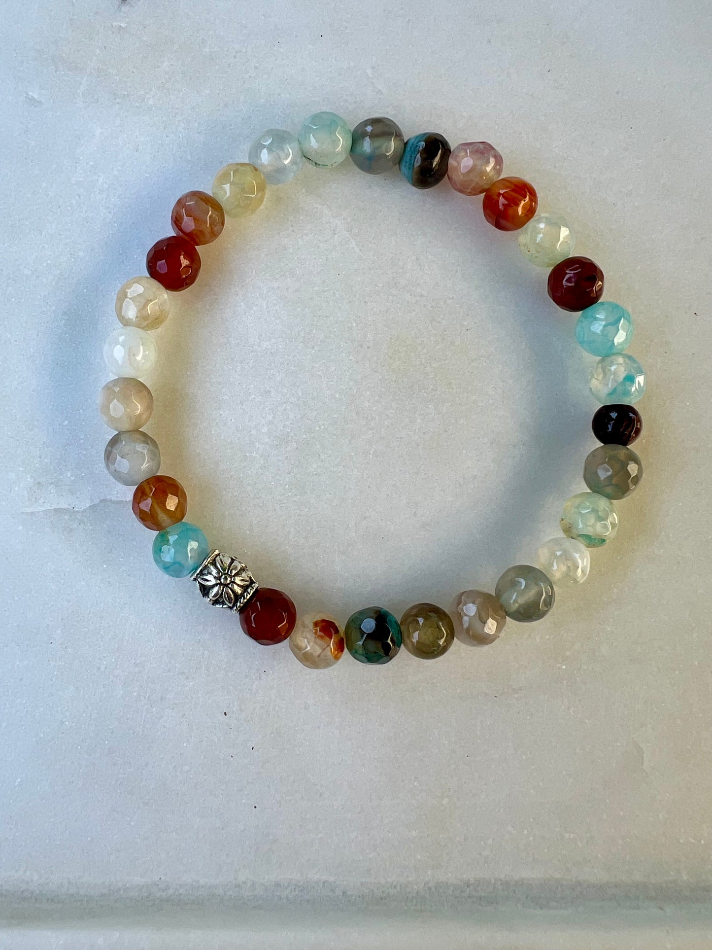 a beaded bracelet with a cross on it