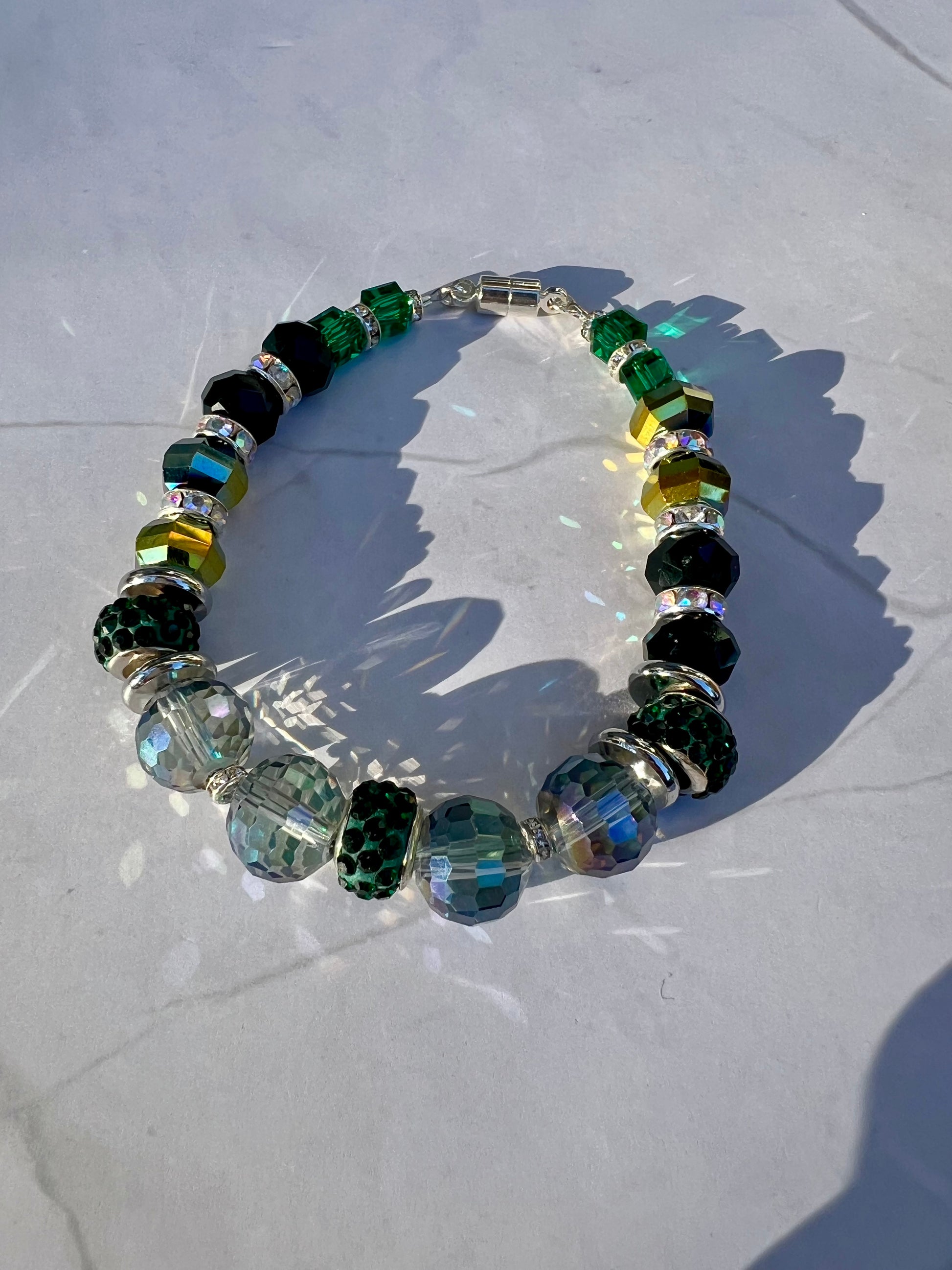 a bracelet made of glass beads on a white surface