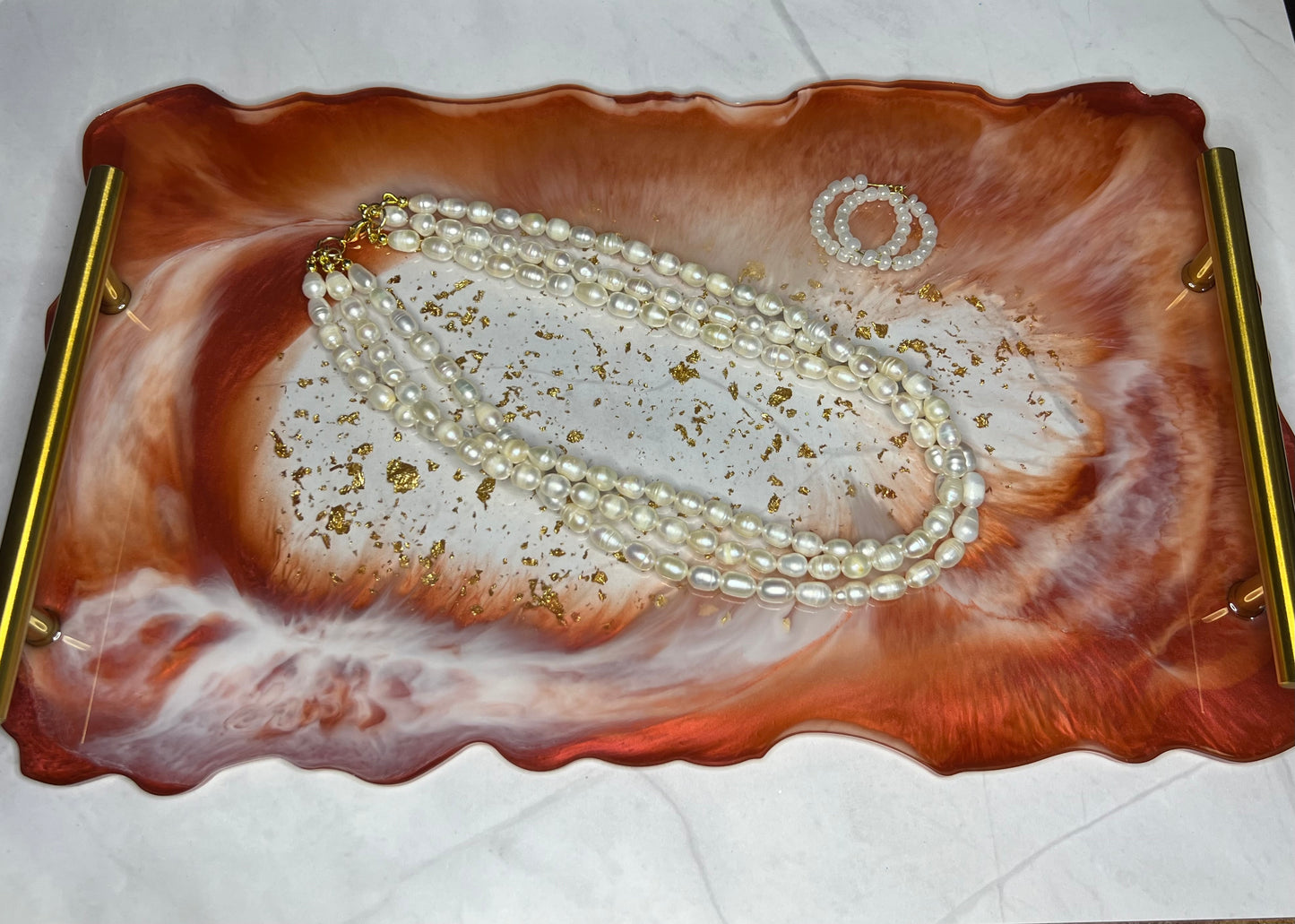 a decorative tray with pearls and pearls on it