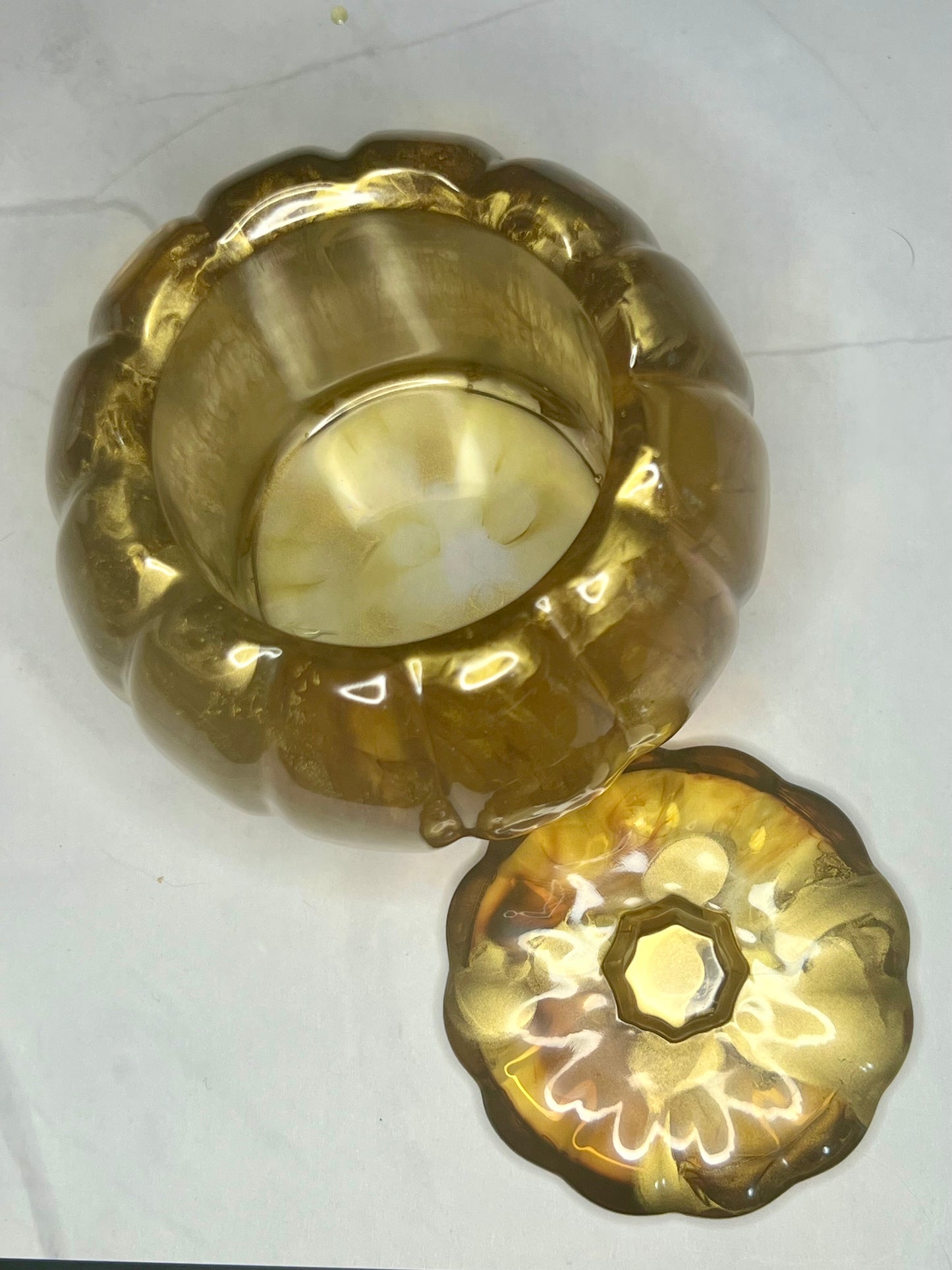 a pair of gold dishes sitting on top of a white table