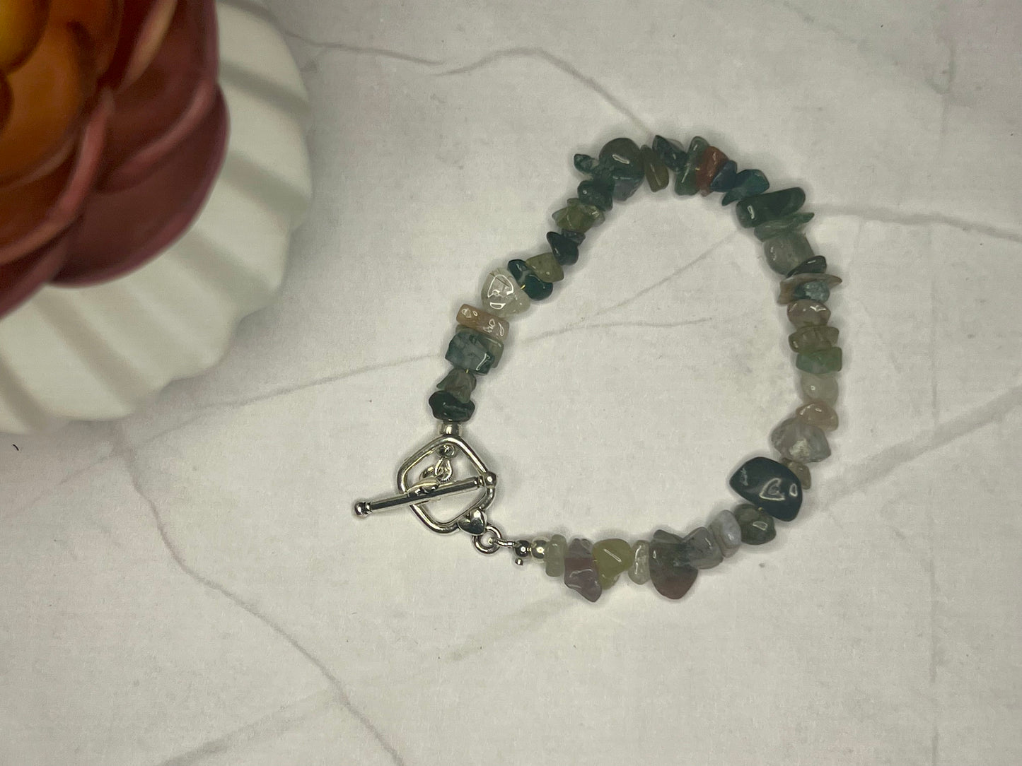 a beaded bracelet with a heart charm