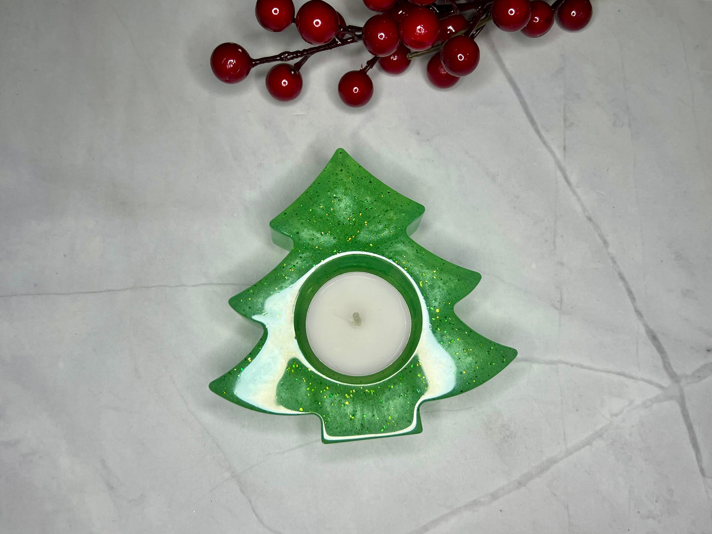 a green candle holder with a candle on top of it