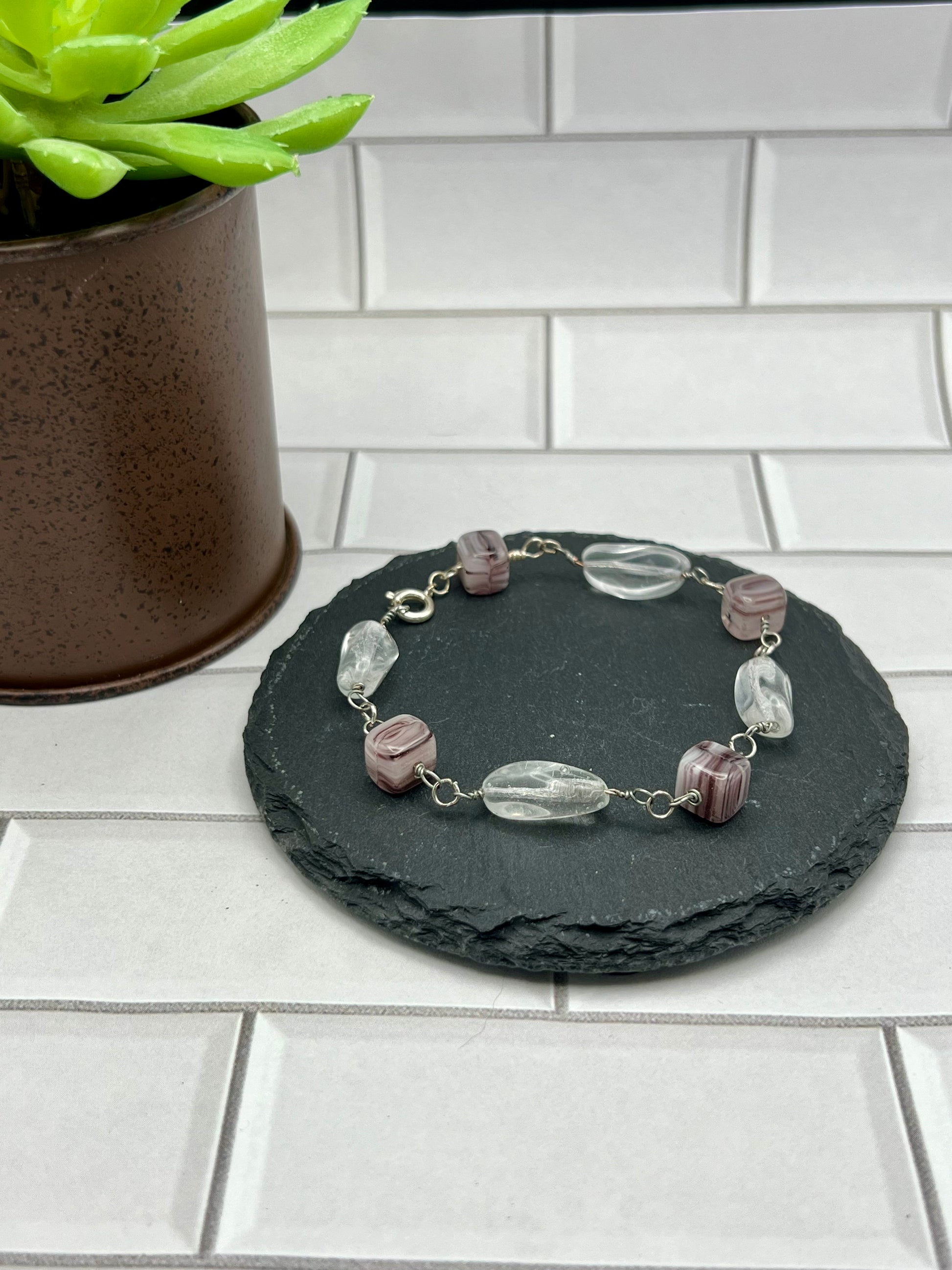 a bracelet with beads on a black stone