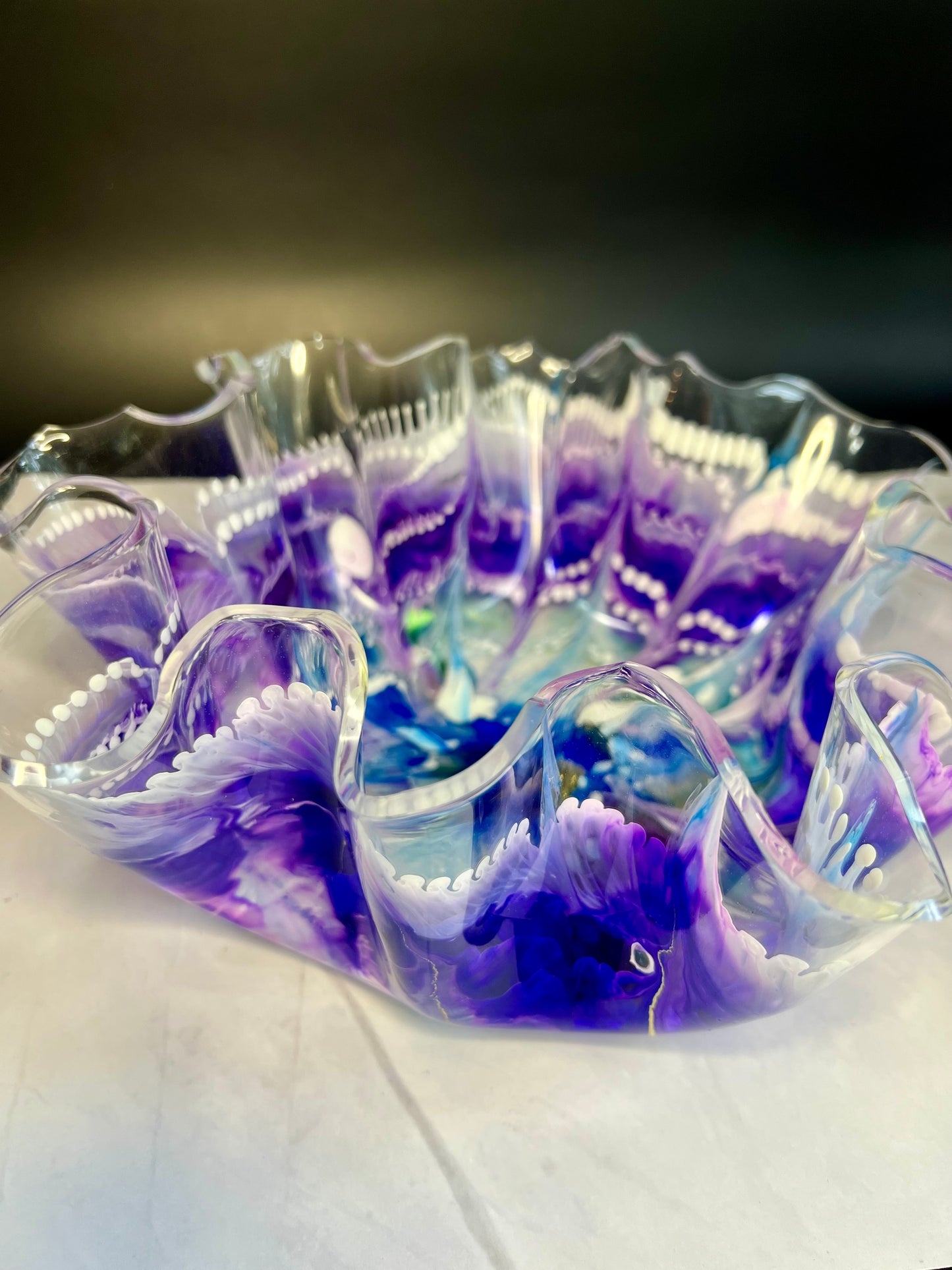 a glass bowl sitting on top of a white table