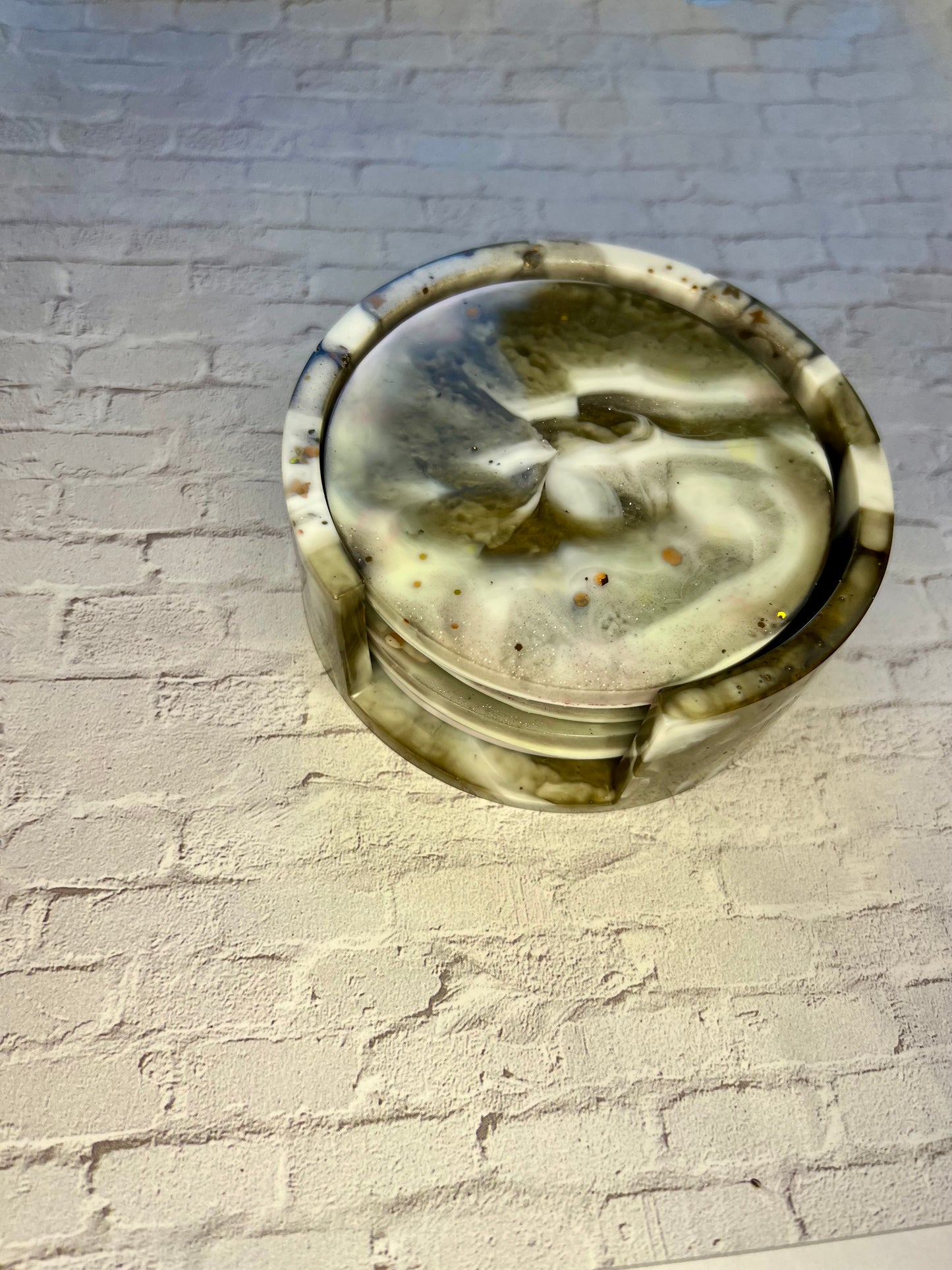 a glass dish sitting on top of a white brick wall