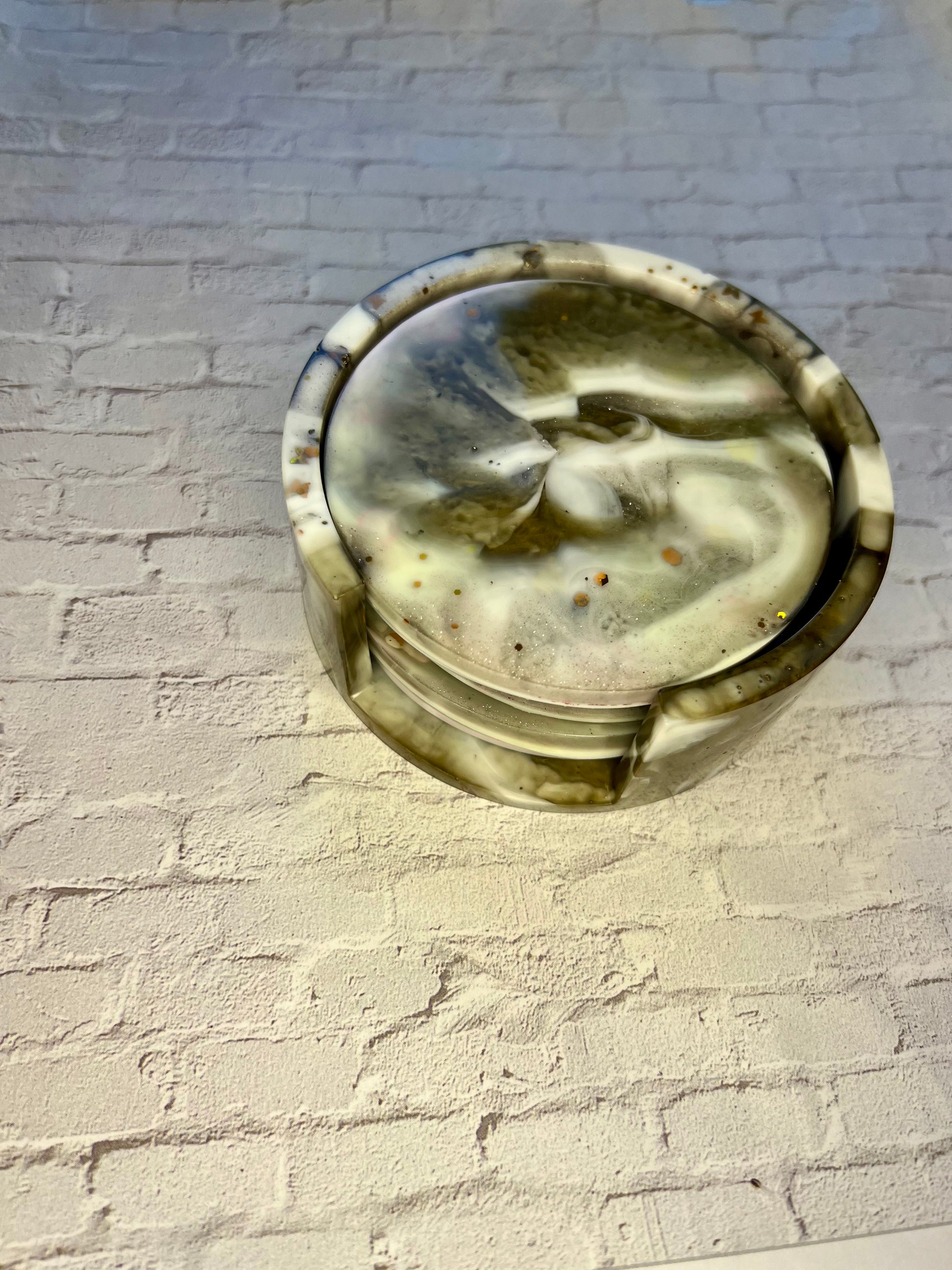 a glass dish sitting on top of a white brick wall