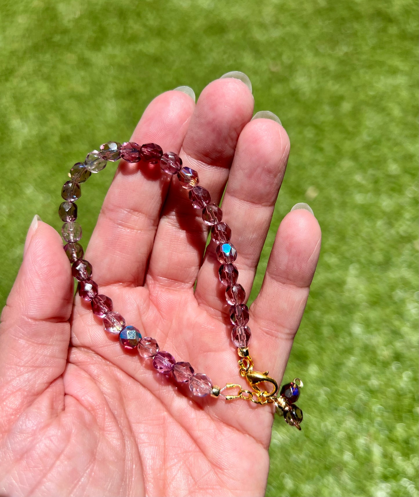 a person holding a long beaded necklace in their hand