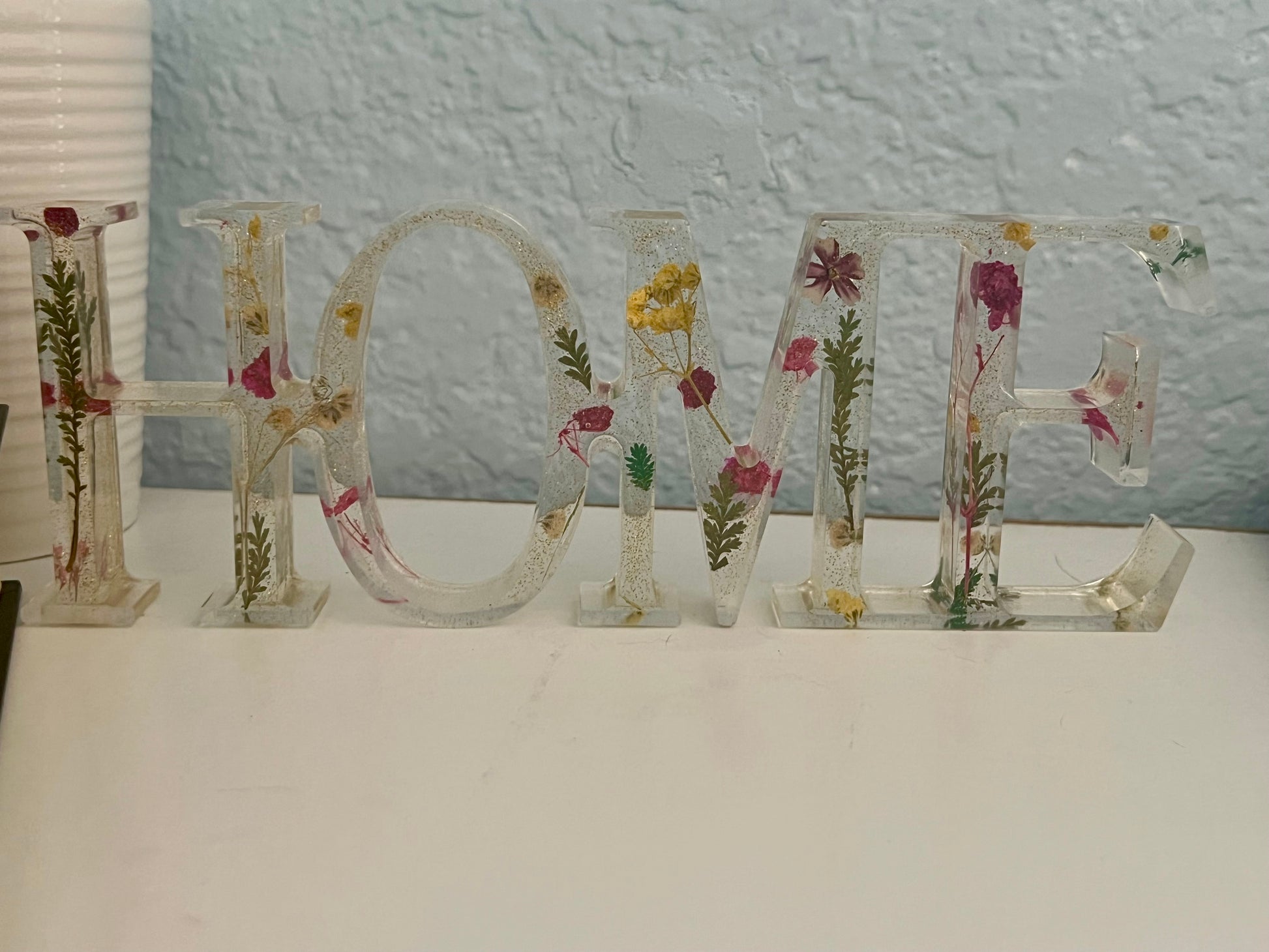 the word home spelled with flowers on a table