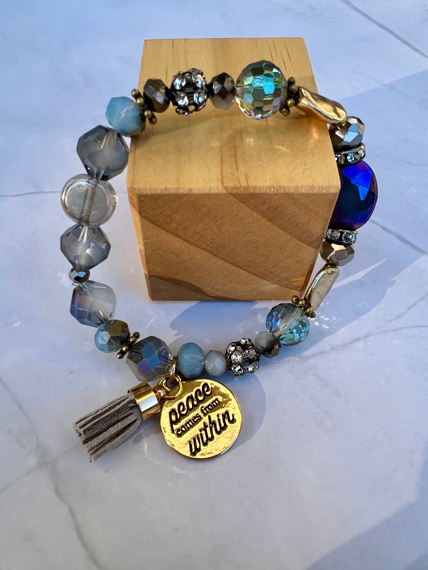 a bracelet with a tassel and a charm