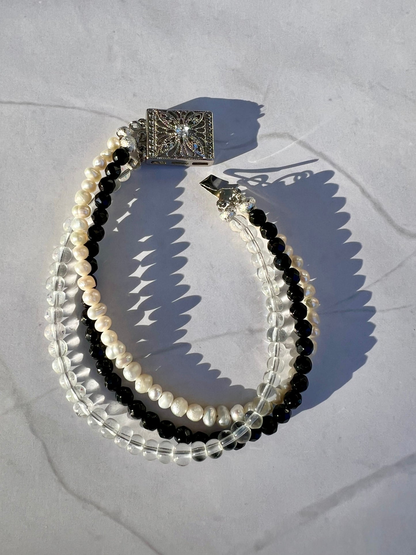 a close up of a bracelet on a white surface