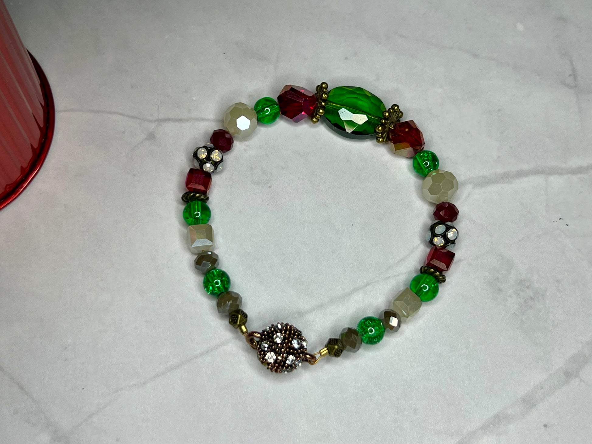 a bracelet with beads and charms on a table