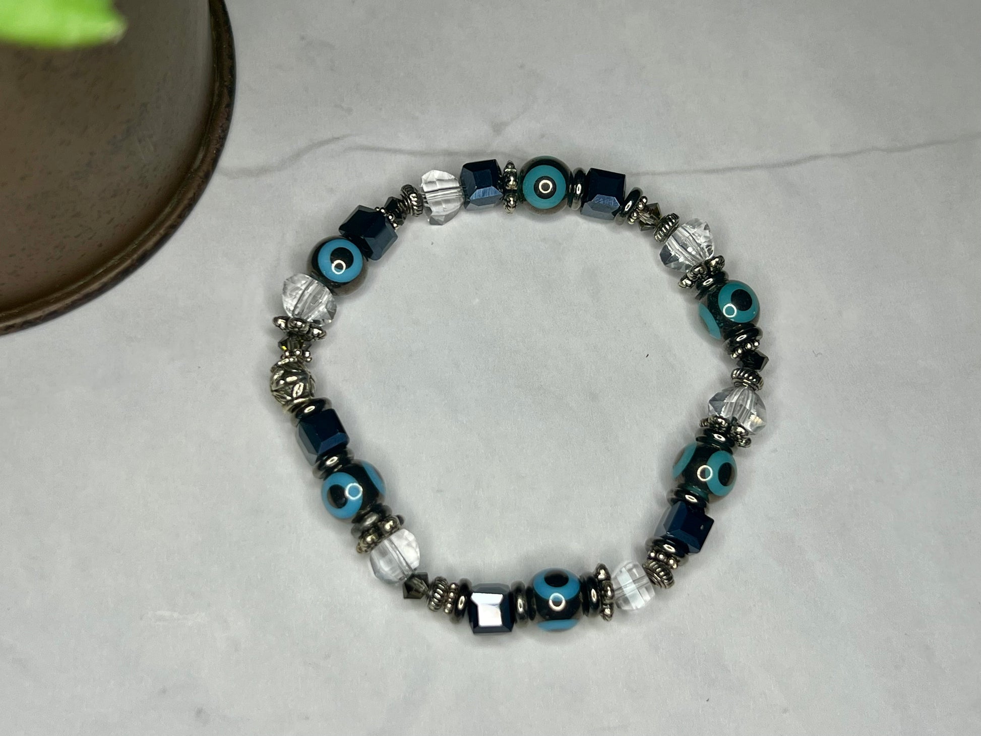 a blue and white bracelet with evil eyes