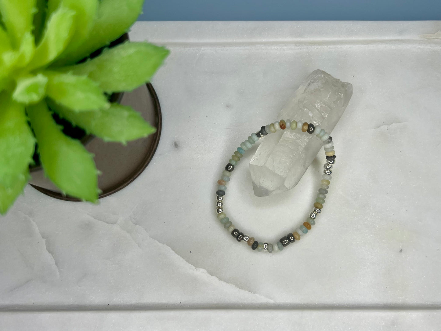 a white marble table with a bracelet on it