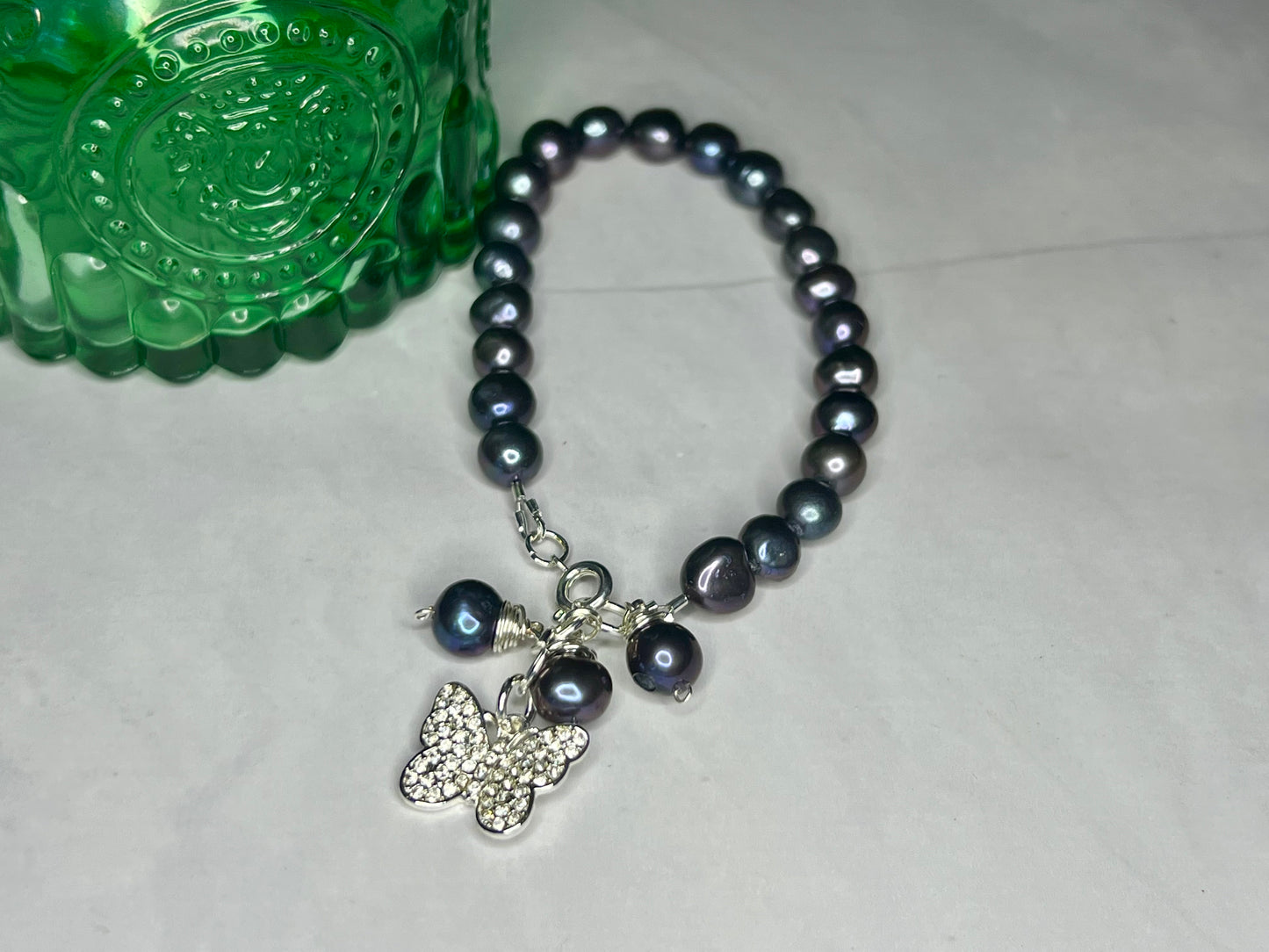 a beaded bracelet with a butterfly charm