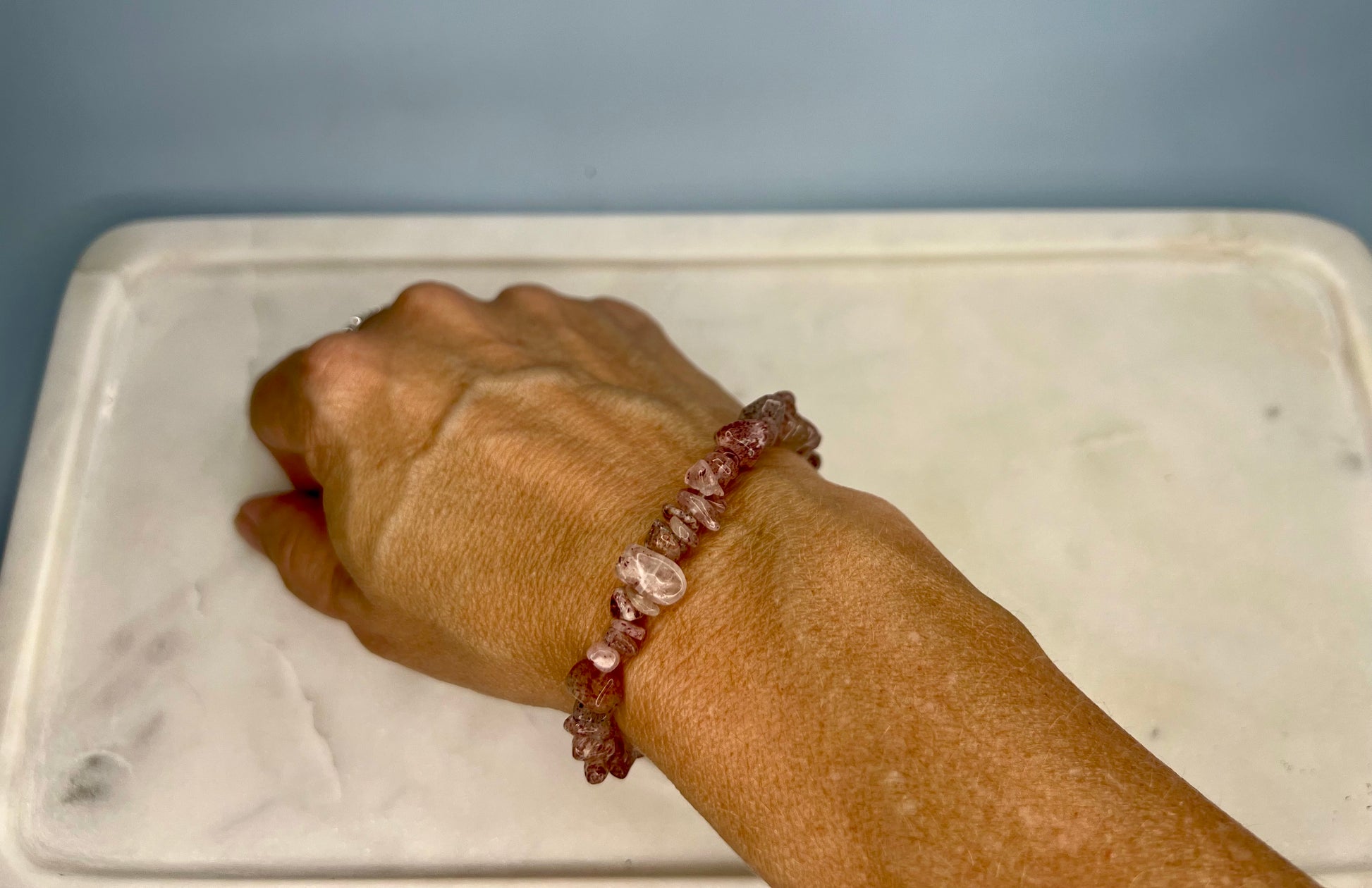 a person's arm with a bracelet on it