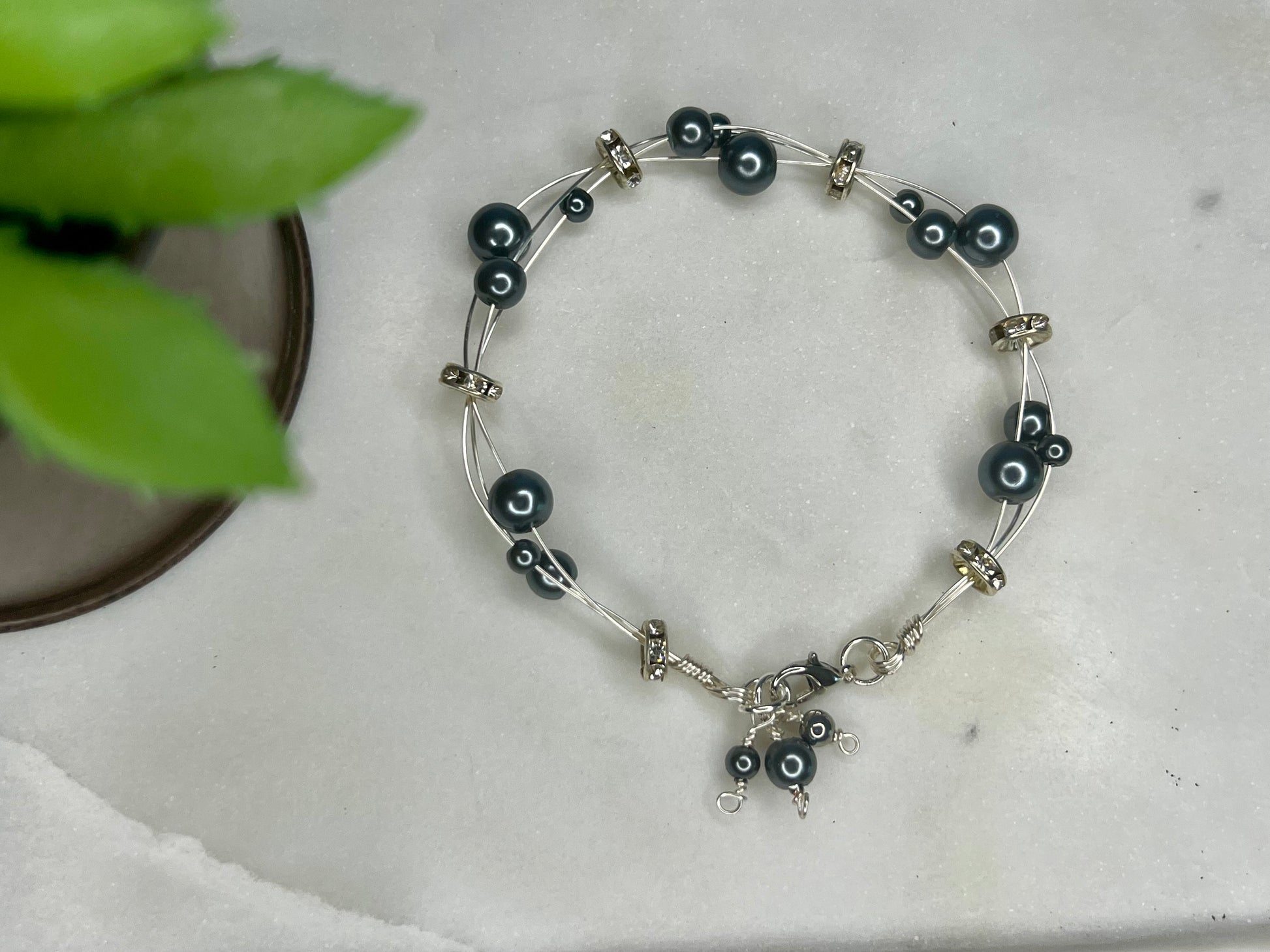 a black and silver beaded bracelet on a table