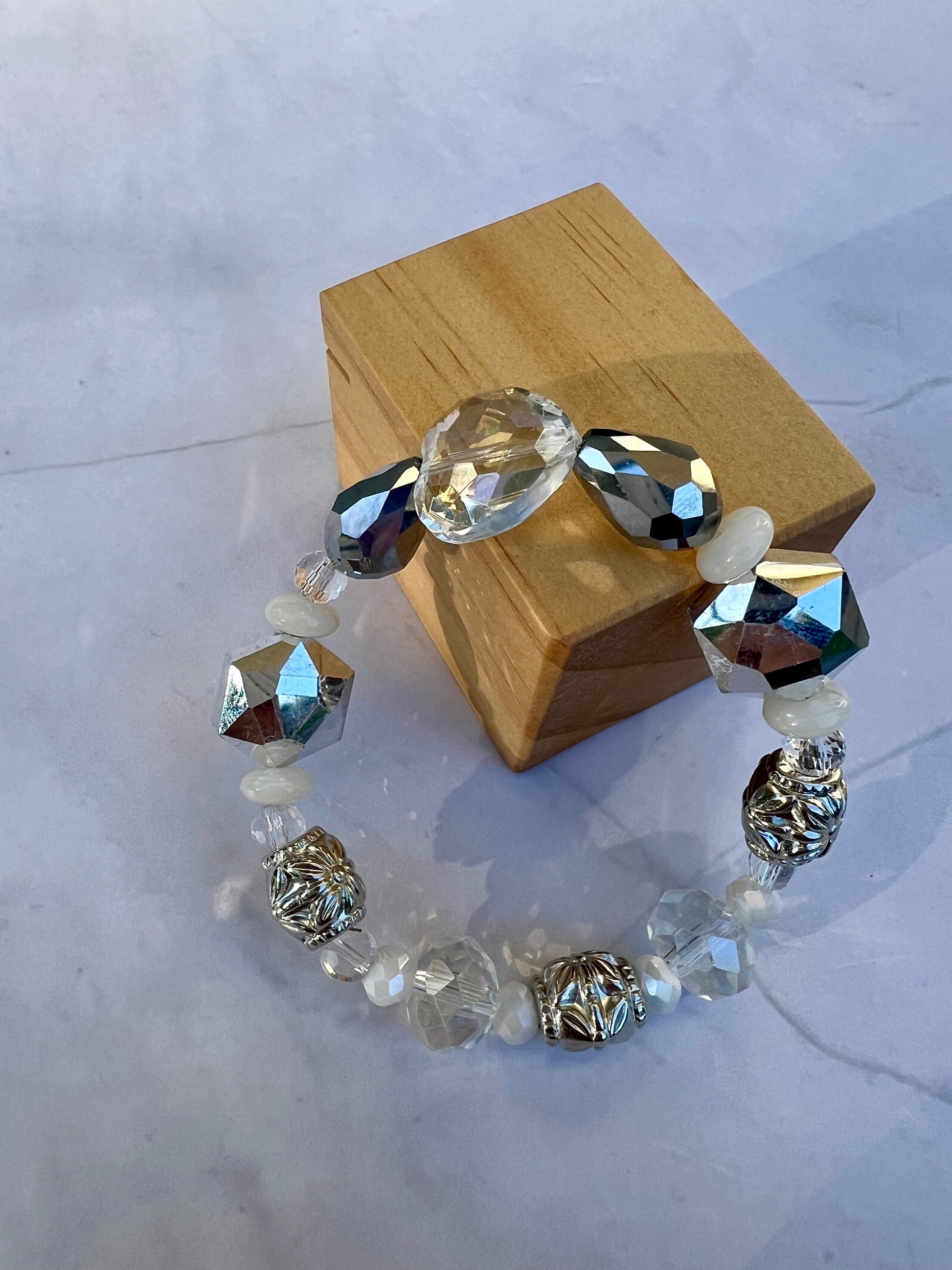 a bracelet made of glass beads and a wooden box