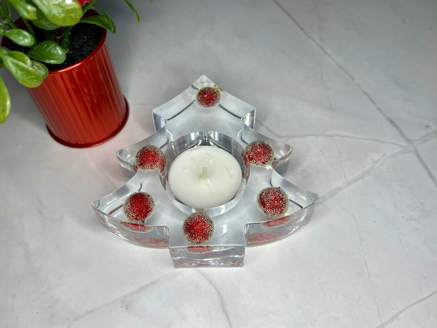 a glass candle holder with a candle inside of it