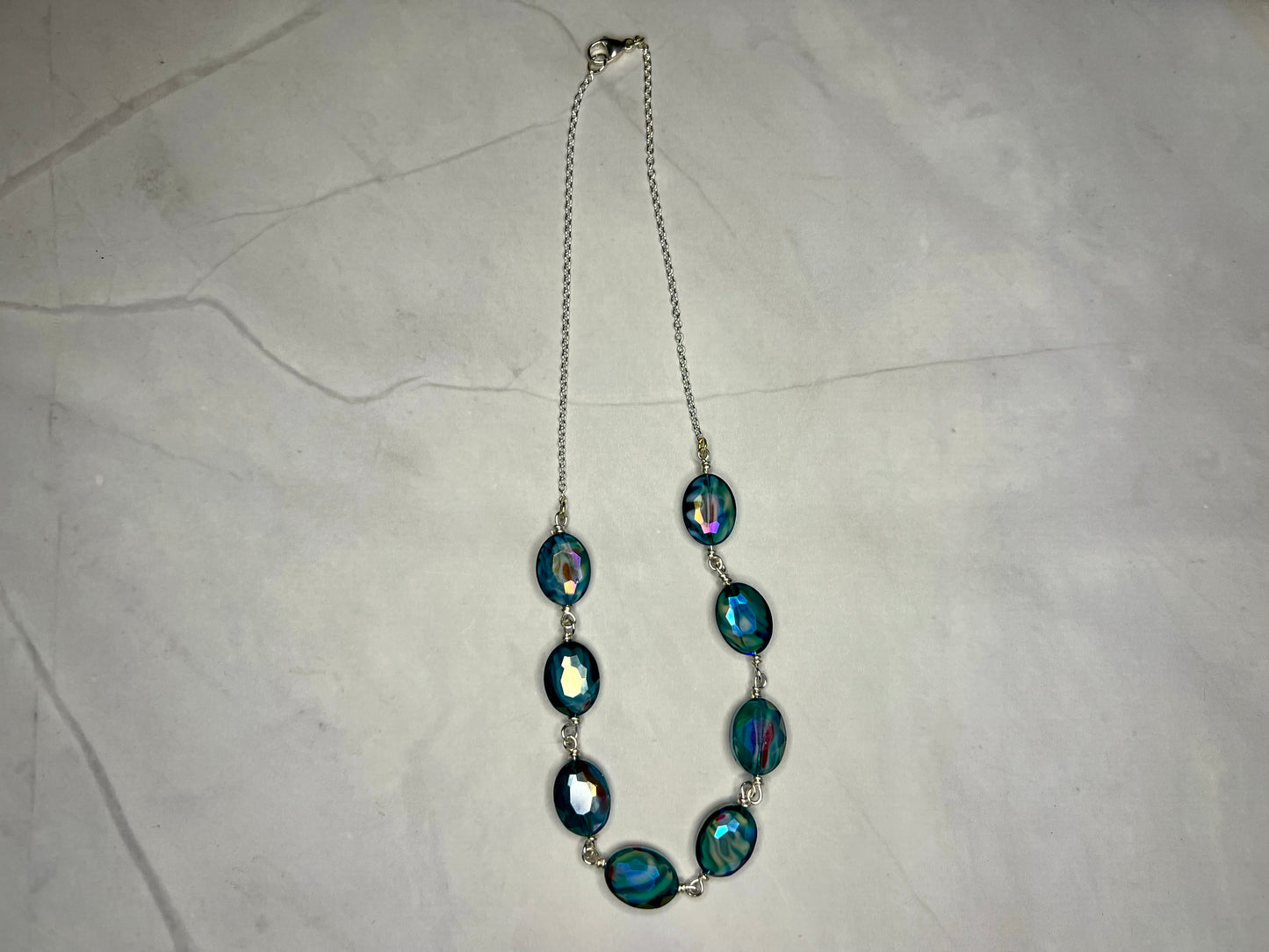 a long necklace with blue and green beads