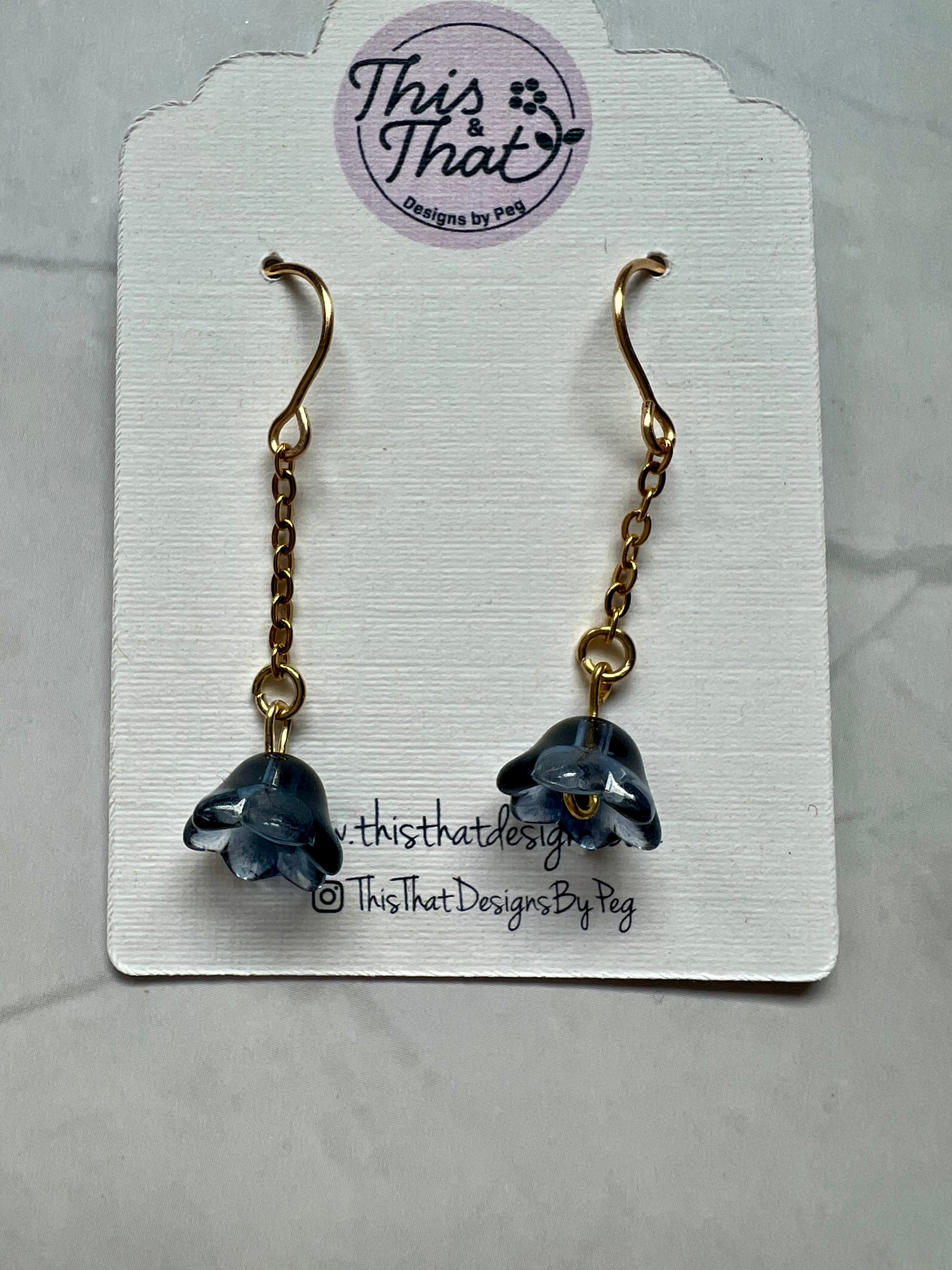 a pair of earrings with a dolphin on it