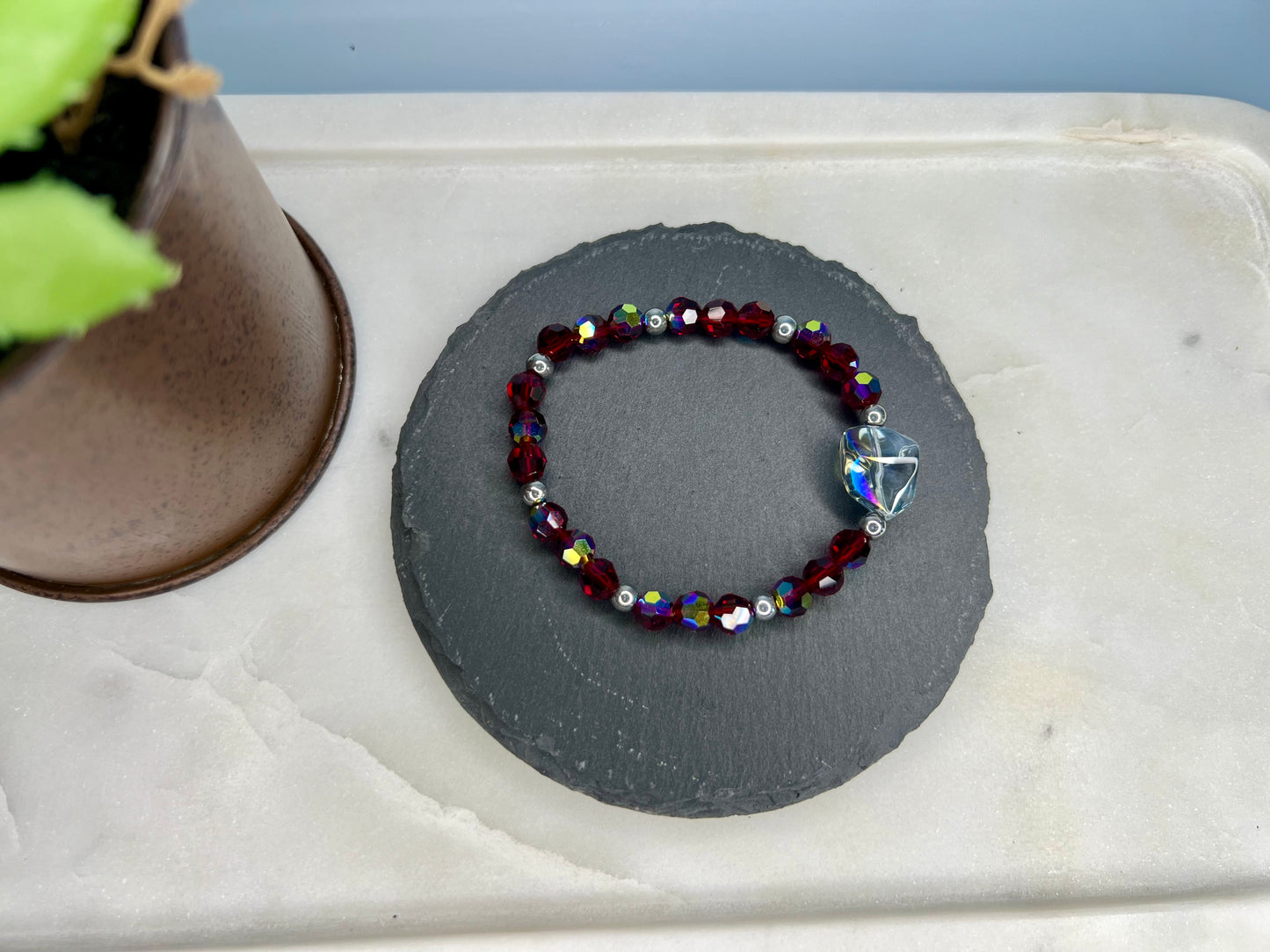 a small beaded bracelet with a cross on it