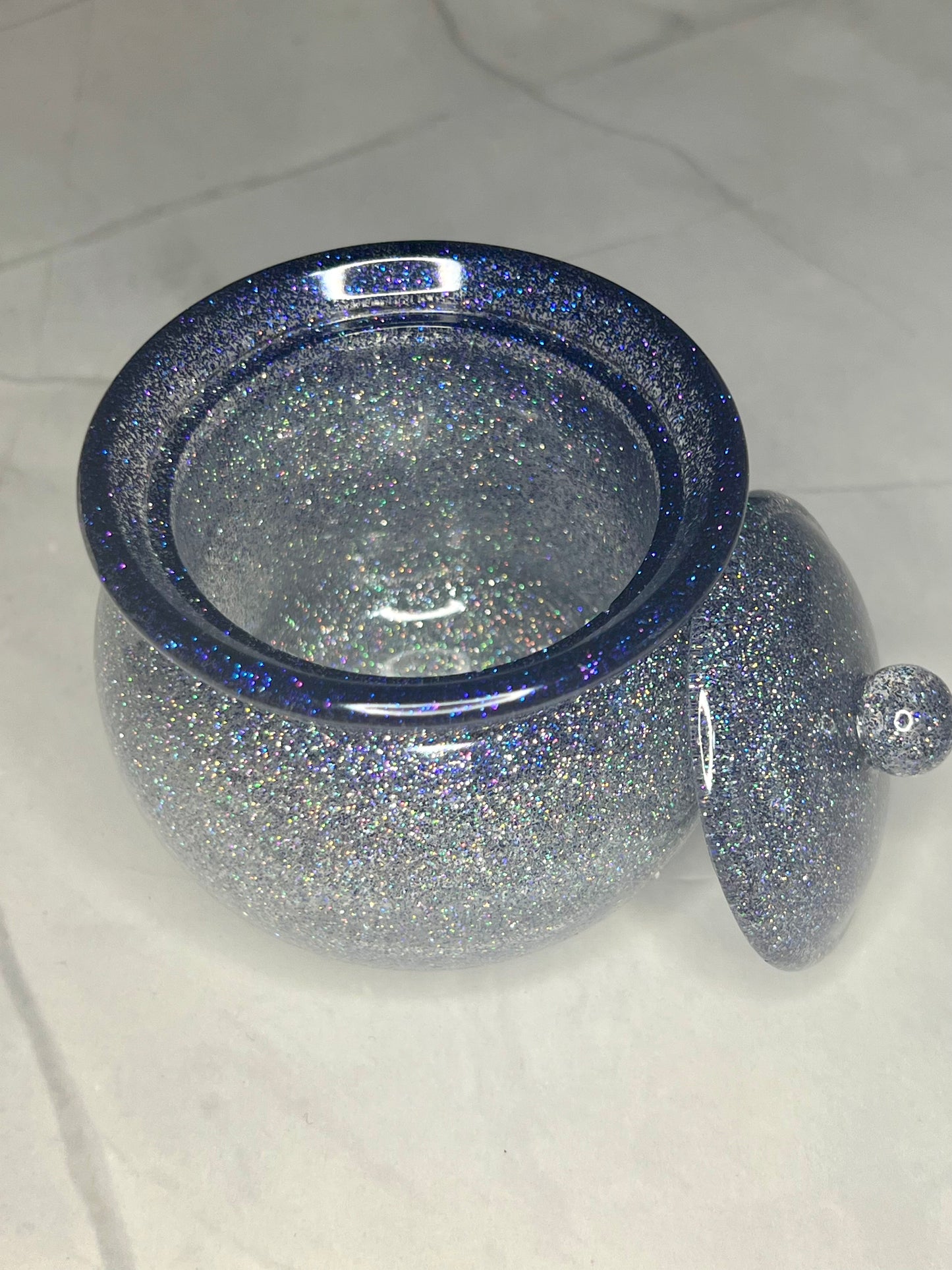 a glass bowl with a lid on a table