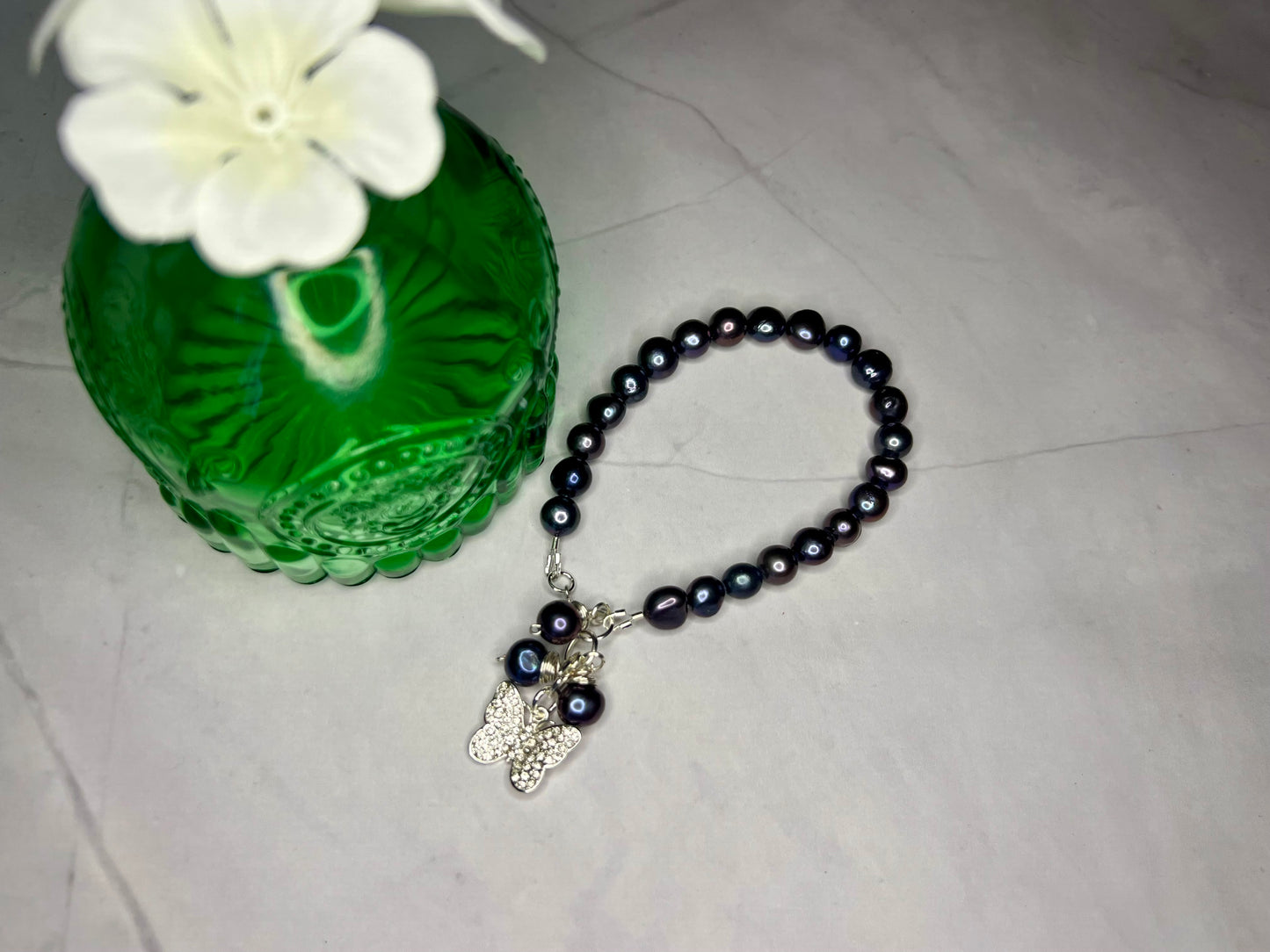 a beaded bracelet with a charm and a flower