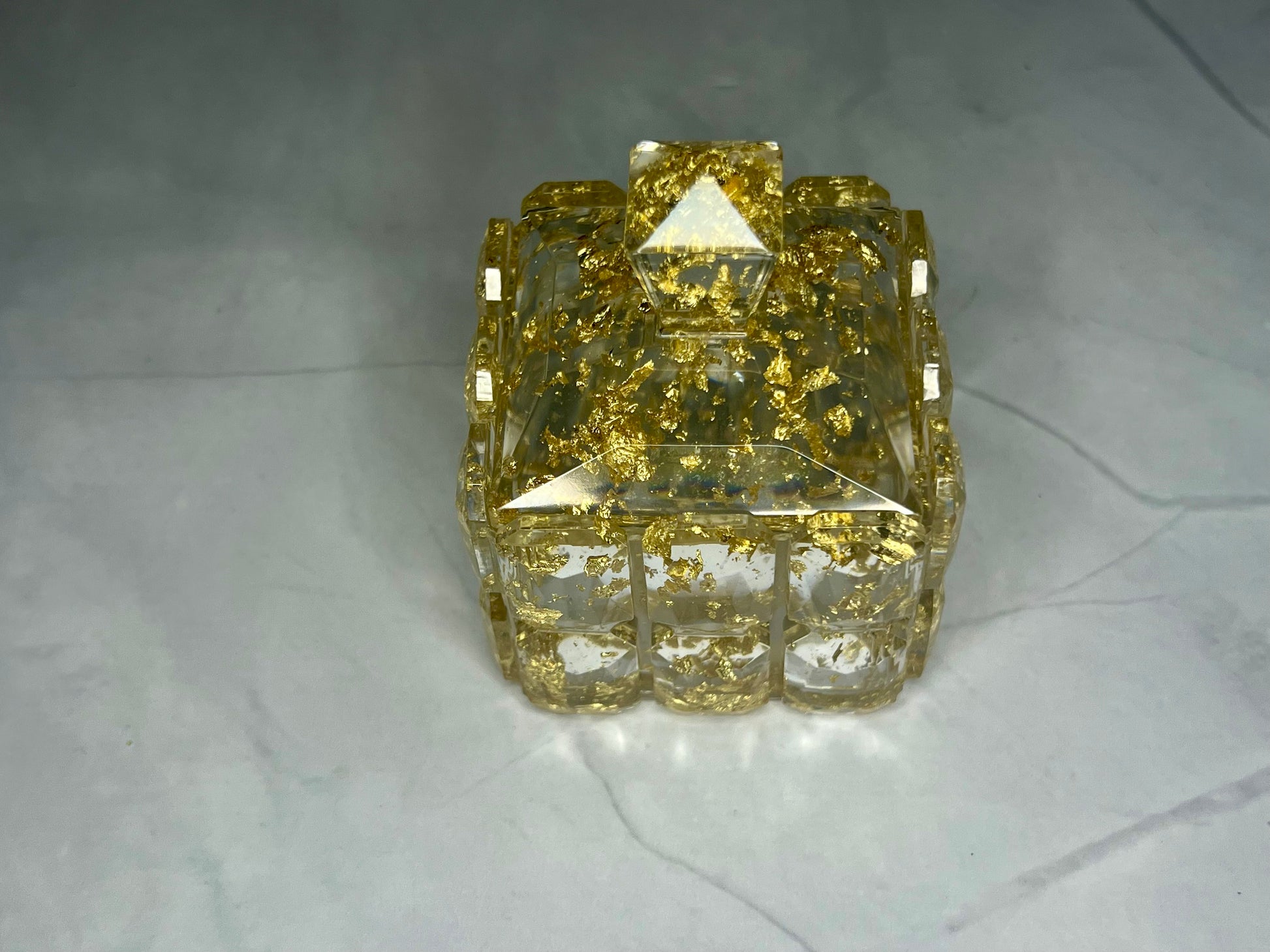 a yellow diamond shaped object sitting on a white surface