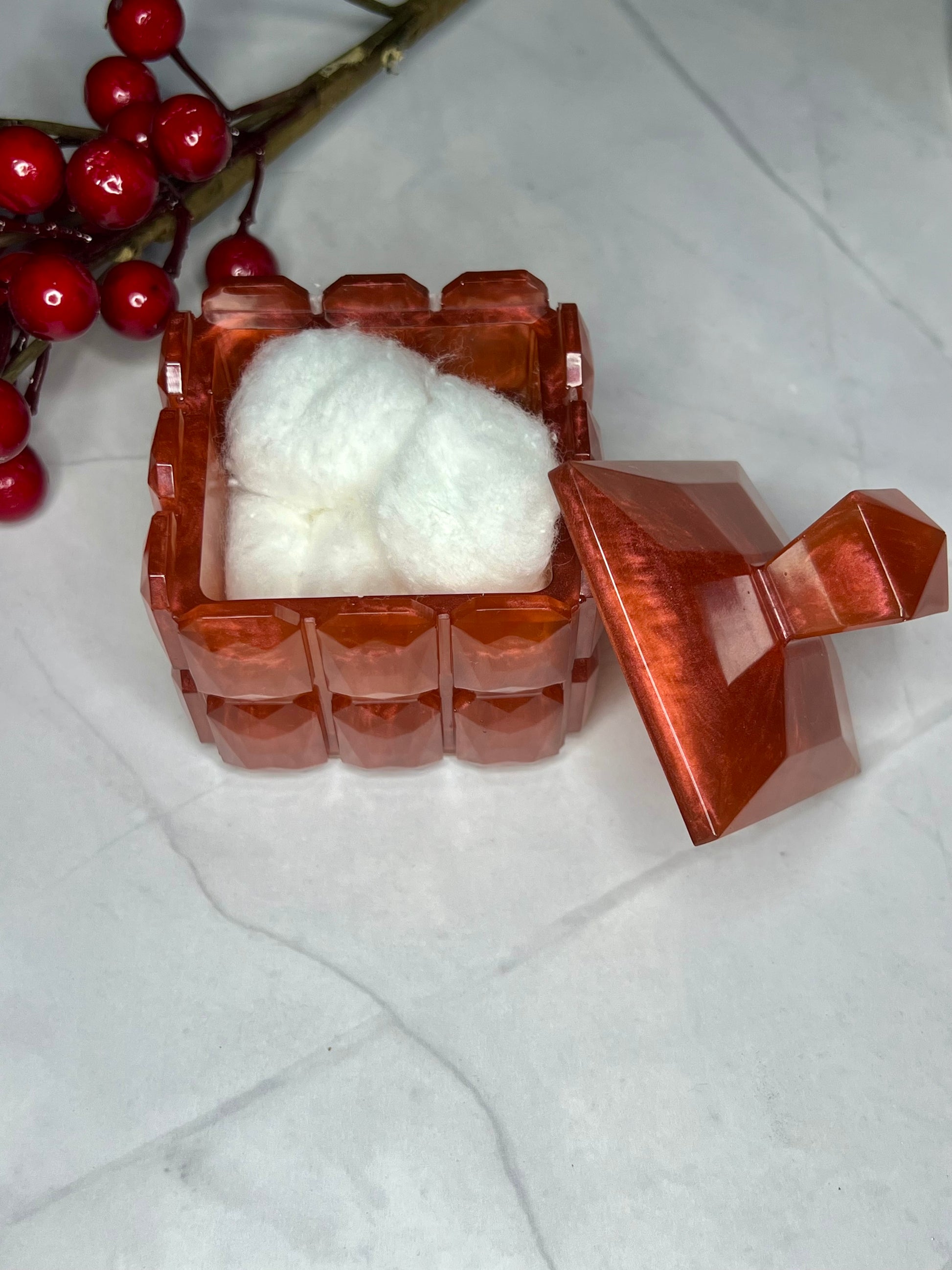 a container of cotton sitting on top of a table