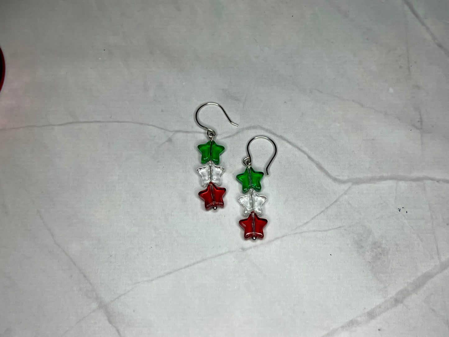 a pair of red, green and silver earrings