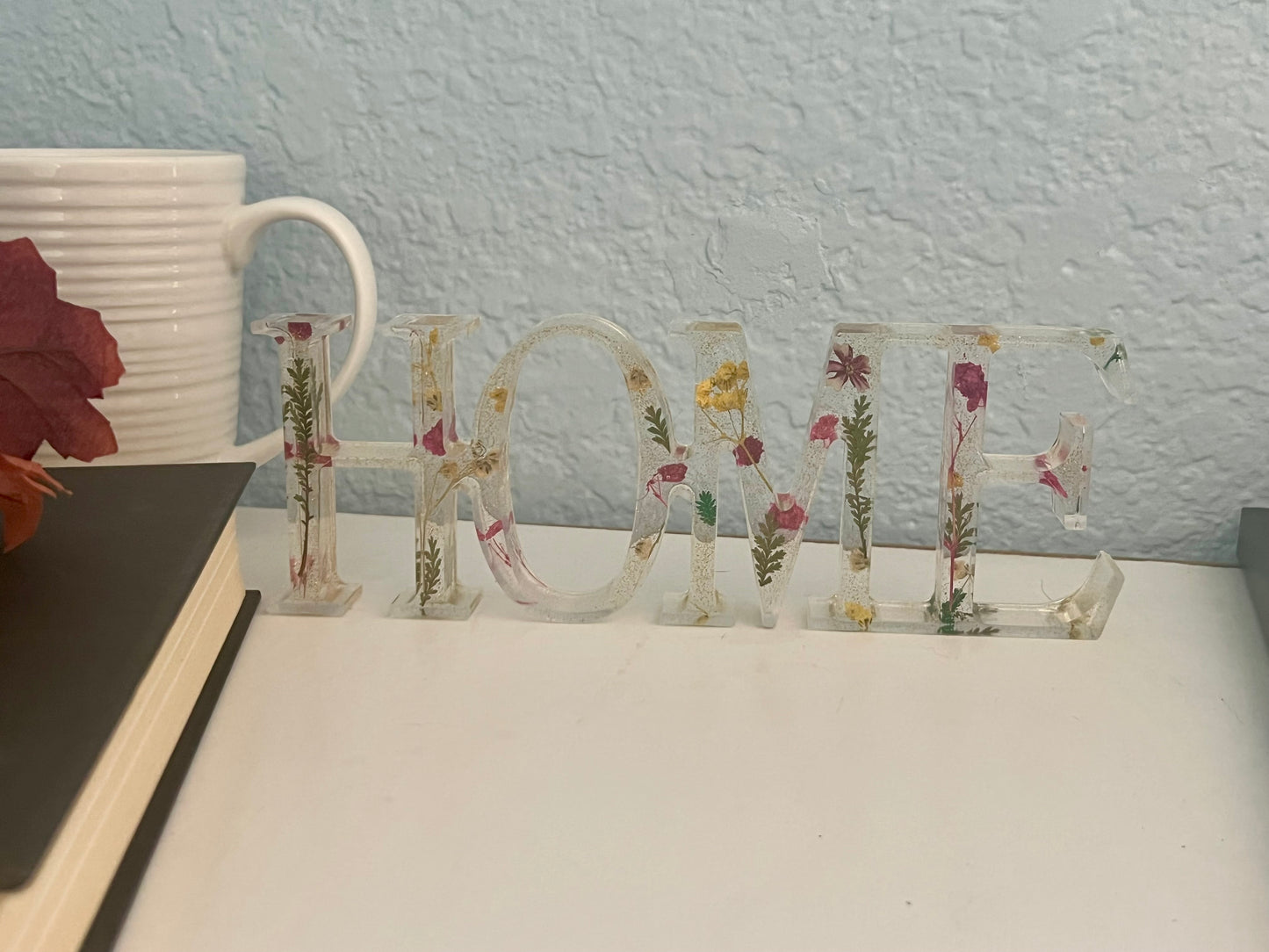 a white table topped with a vase filled with flowers