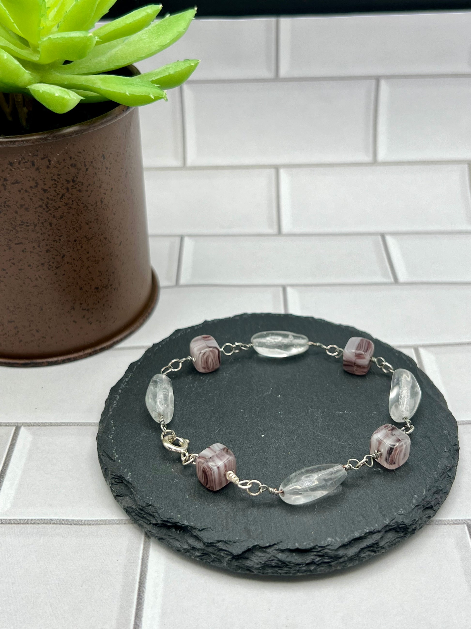 a stone plate with a bracelet on it