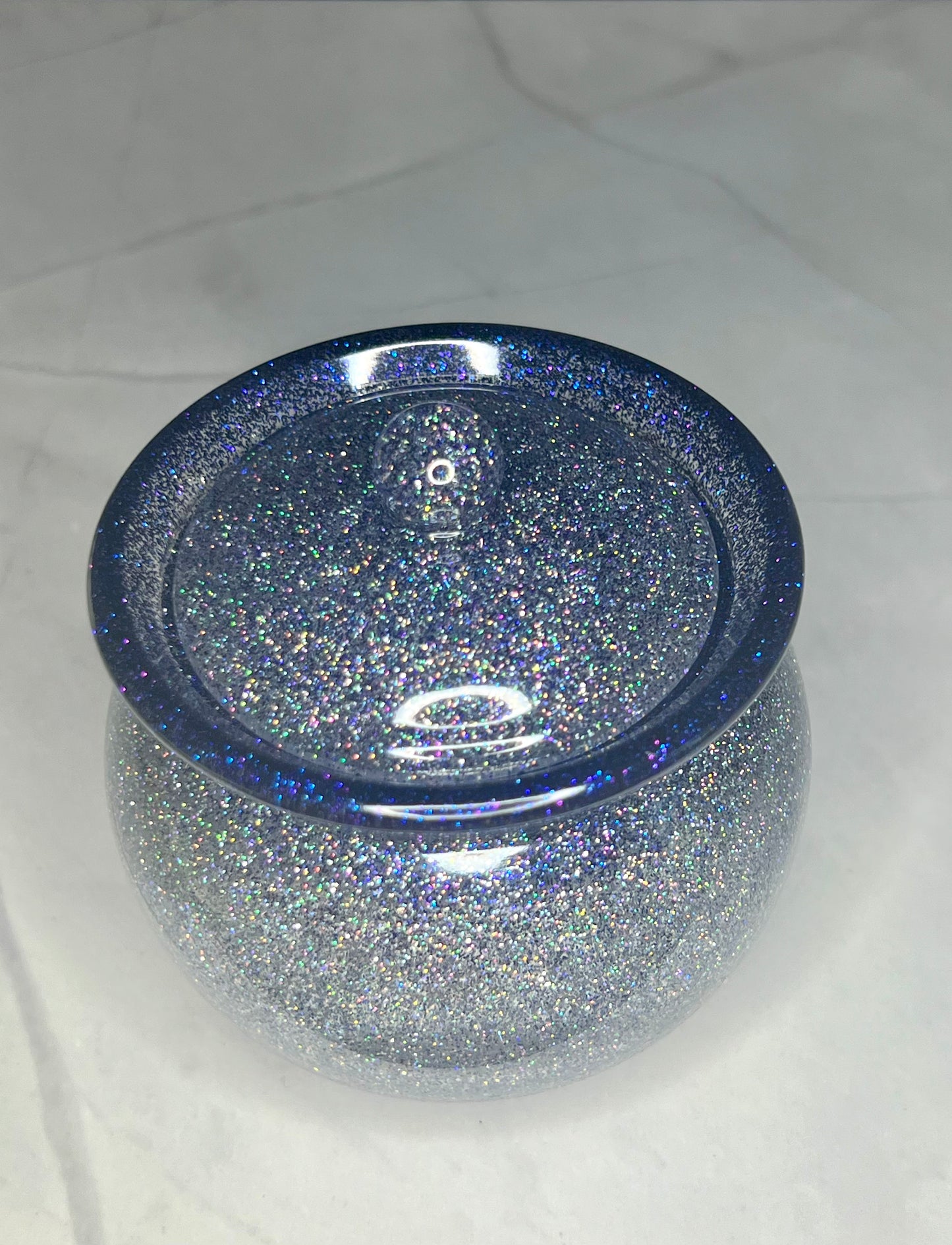 a blue glass bowl with glitter on it