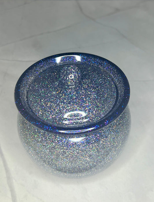 a blue glass bowl with glitter on it