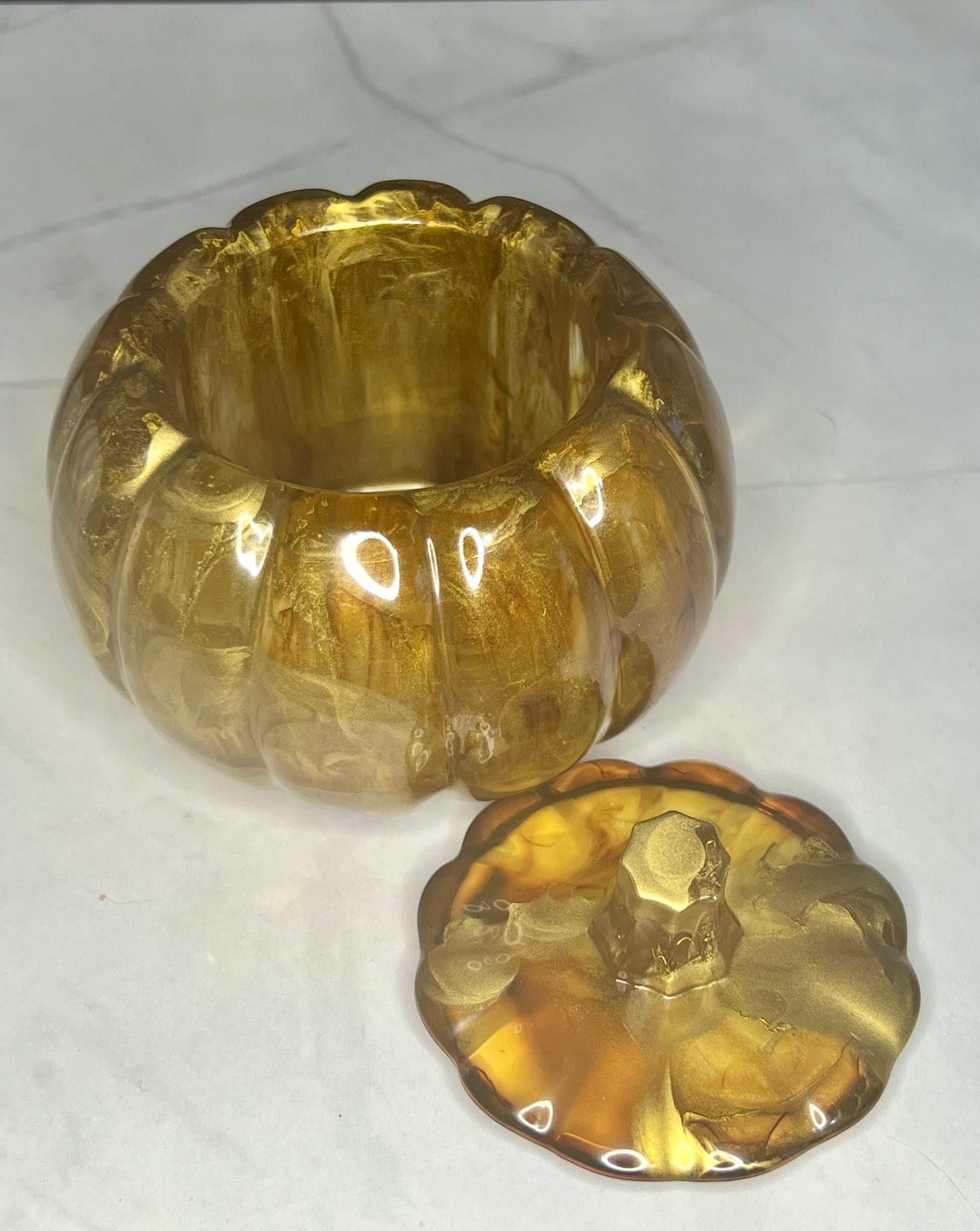 a glass bowl and a gold plate sitting on a table