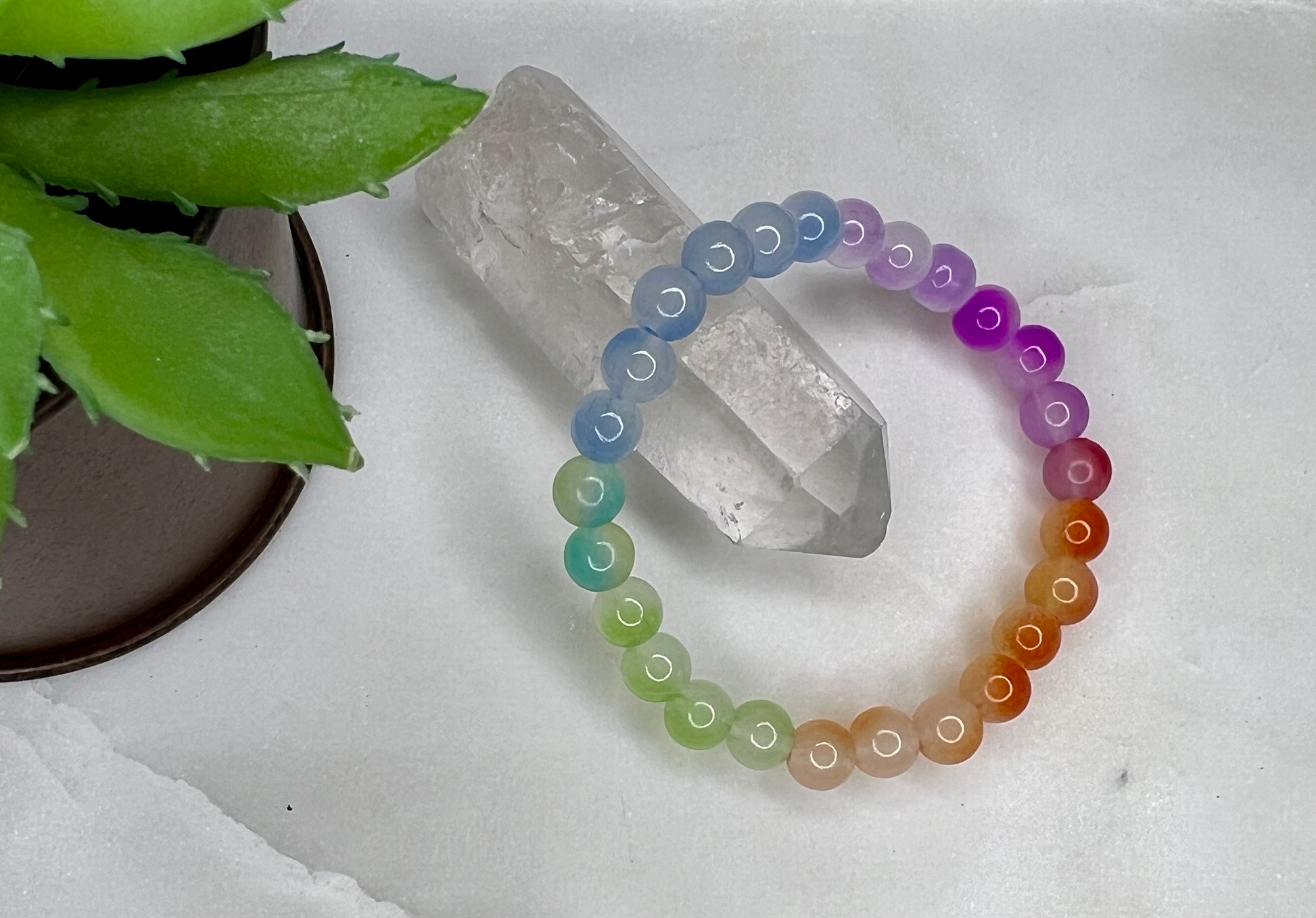 a bracelet with a rainbow colored beaded cord