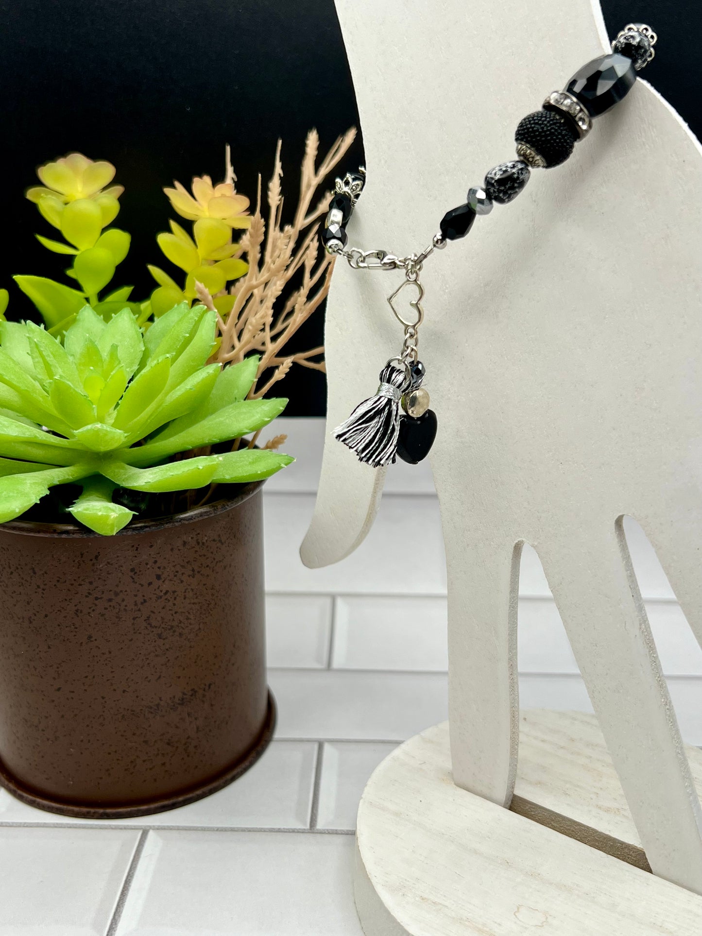 a small plant sits next to a white sculpture