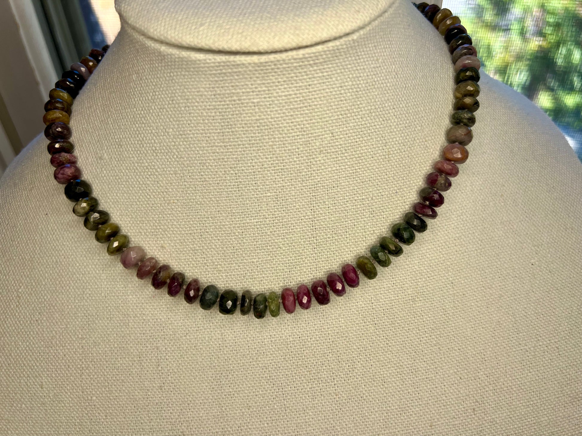 a necklace made of beads on a mannequin