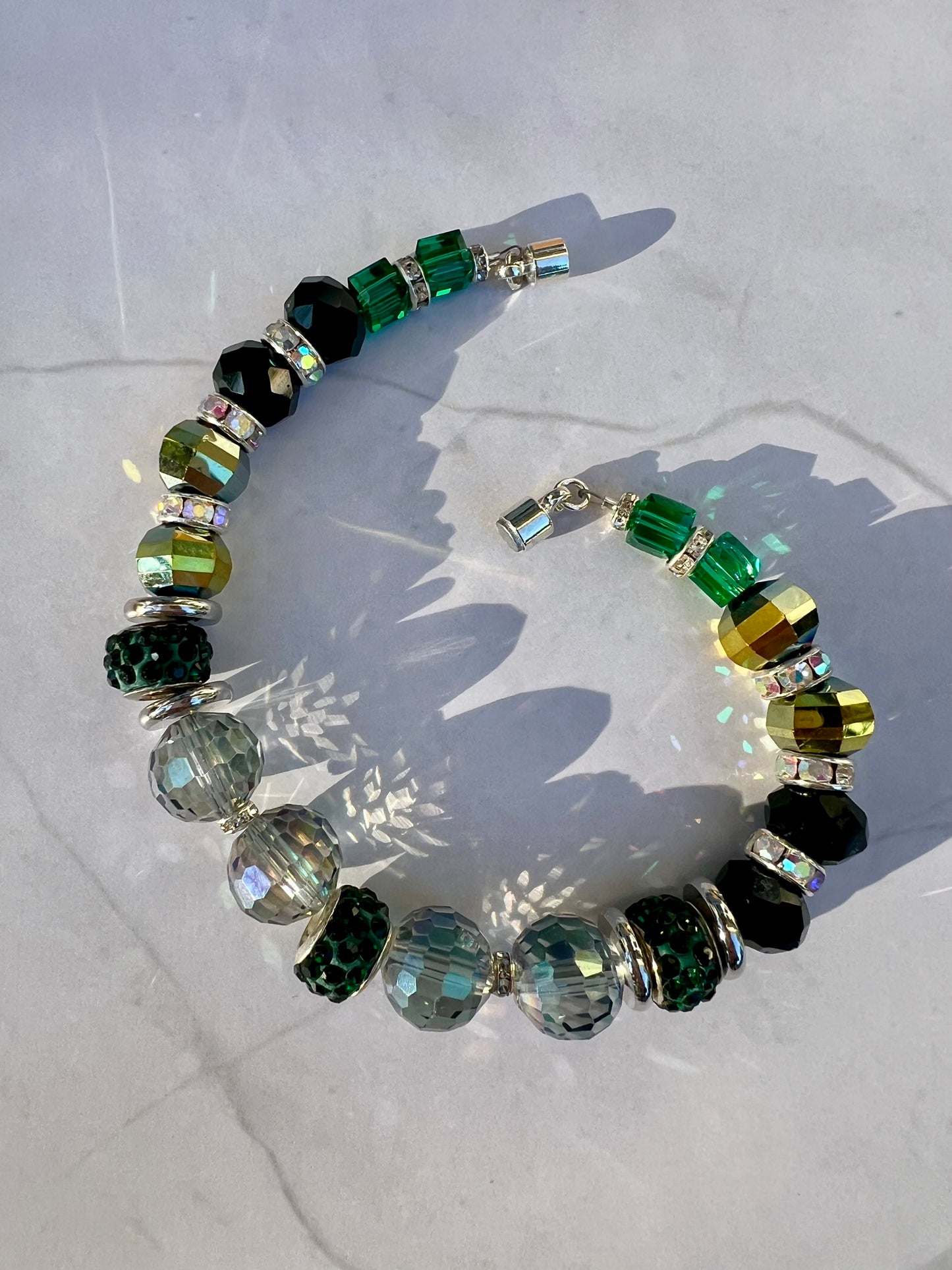 a bracelet made of glass beads and green glass beads