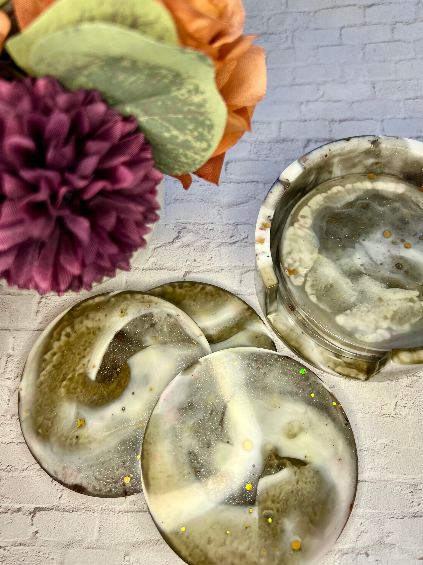 three dirty plates sitting on a table next to a flower